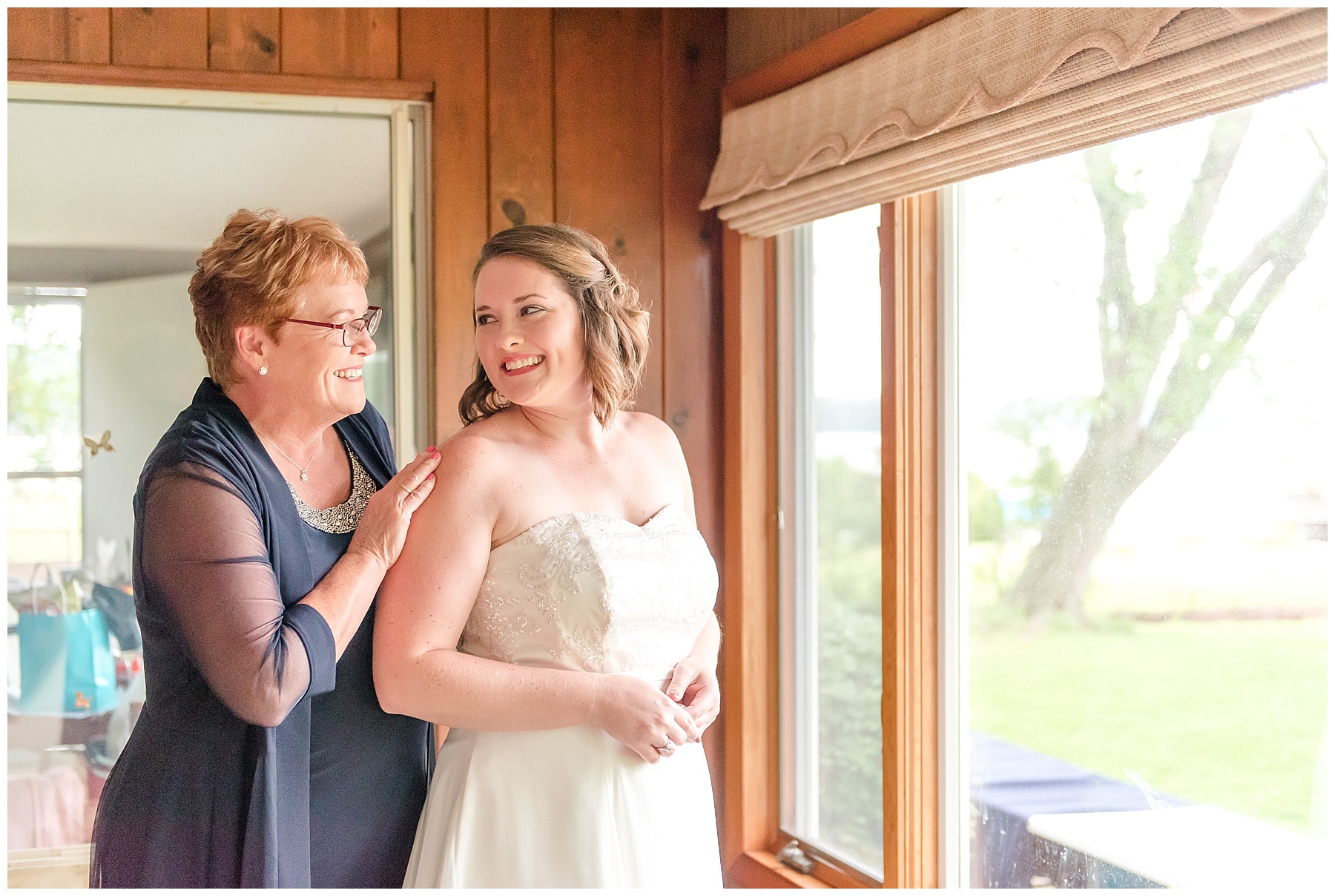 Bride smiling over shoulder at mom in 2018 wedding photography favorites
