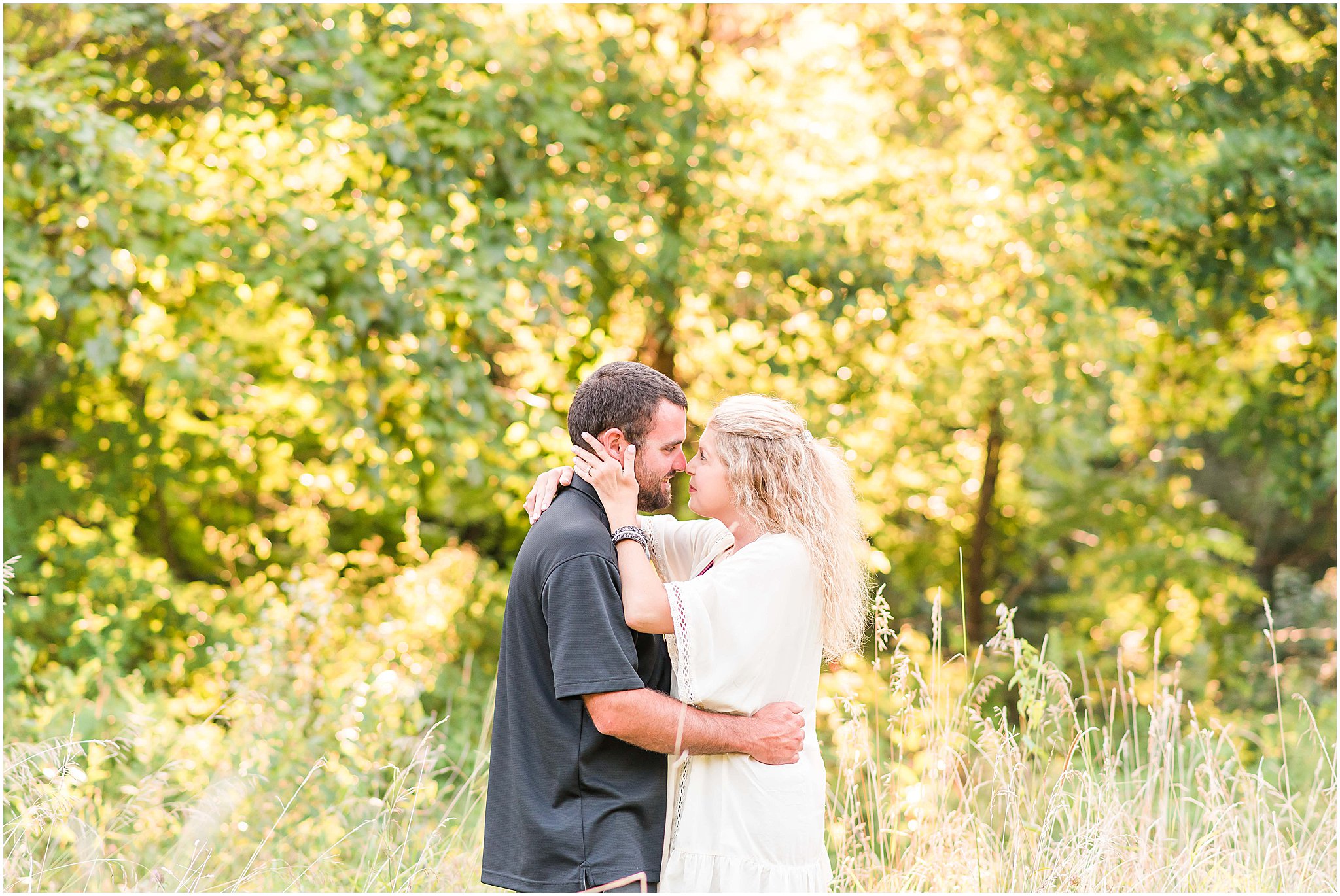 Bloomfield Indiana engagement session couple touching noses in field at sunset