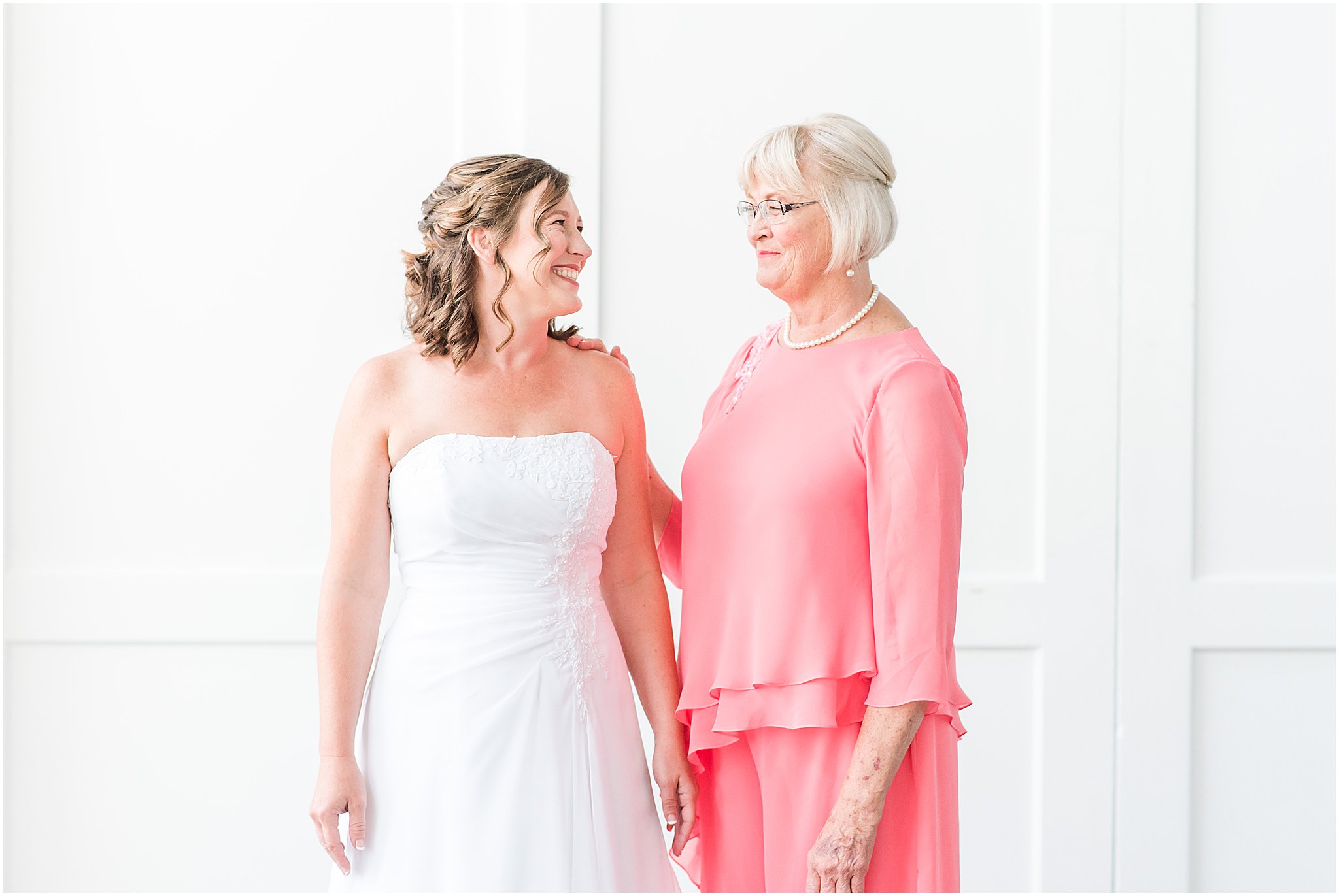 Bride and Mother smiling at each other at The Hawthorns Golf and Country Club