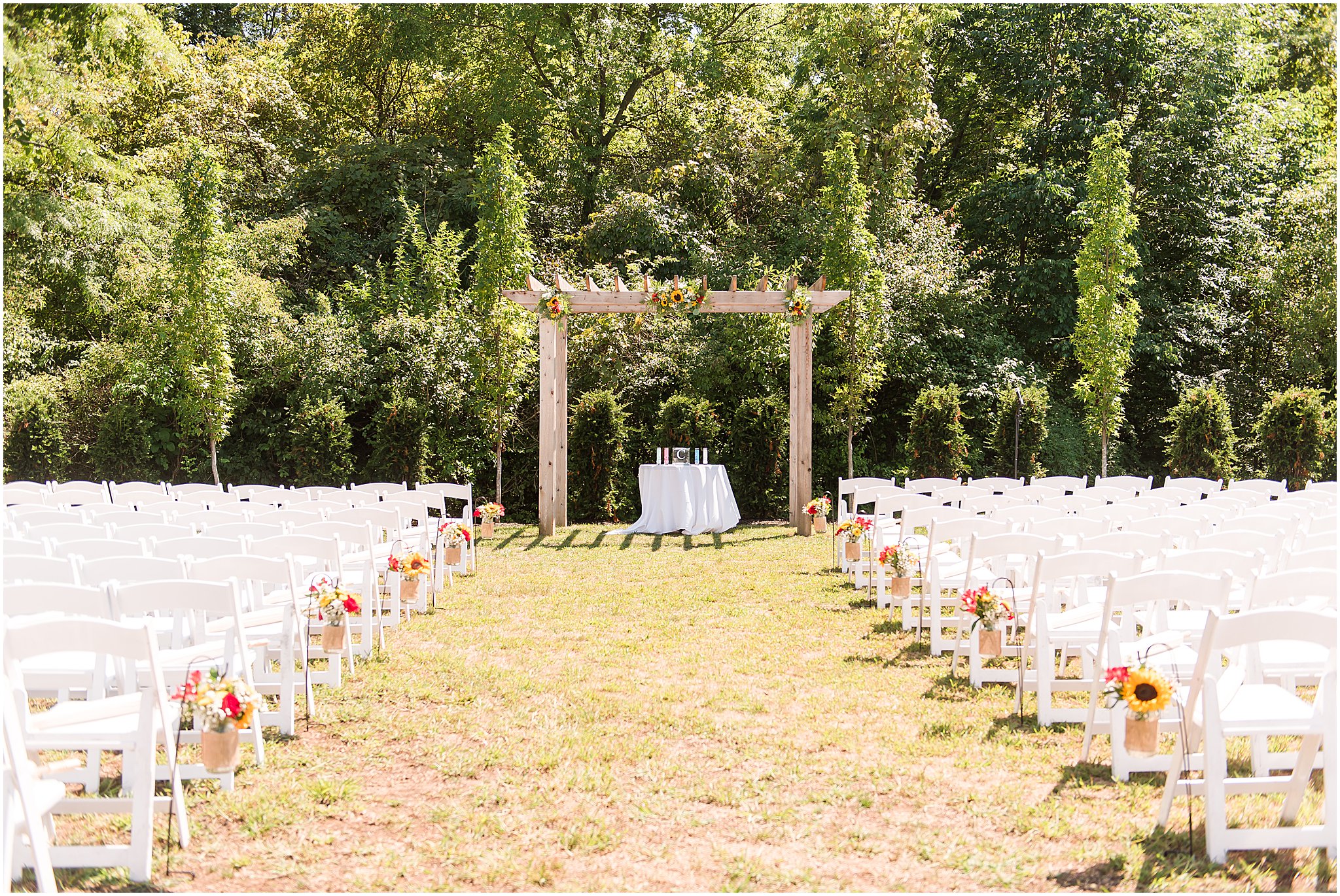 Sunflower and red roses wedding outdoor ceremony decor at The Hawthorns Golf and Country Club