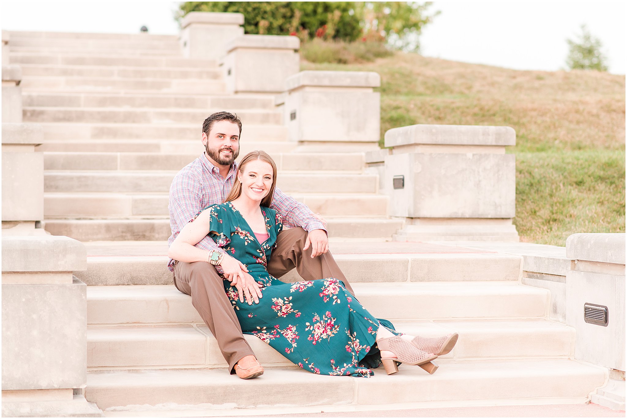 Bride and groom sitting and snuggling on stairs during Coxhall Gardens engagement session