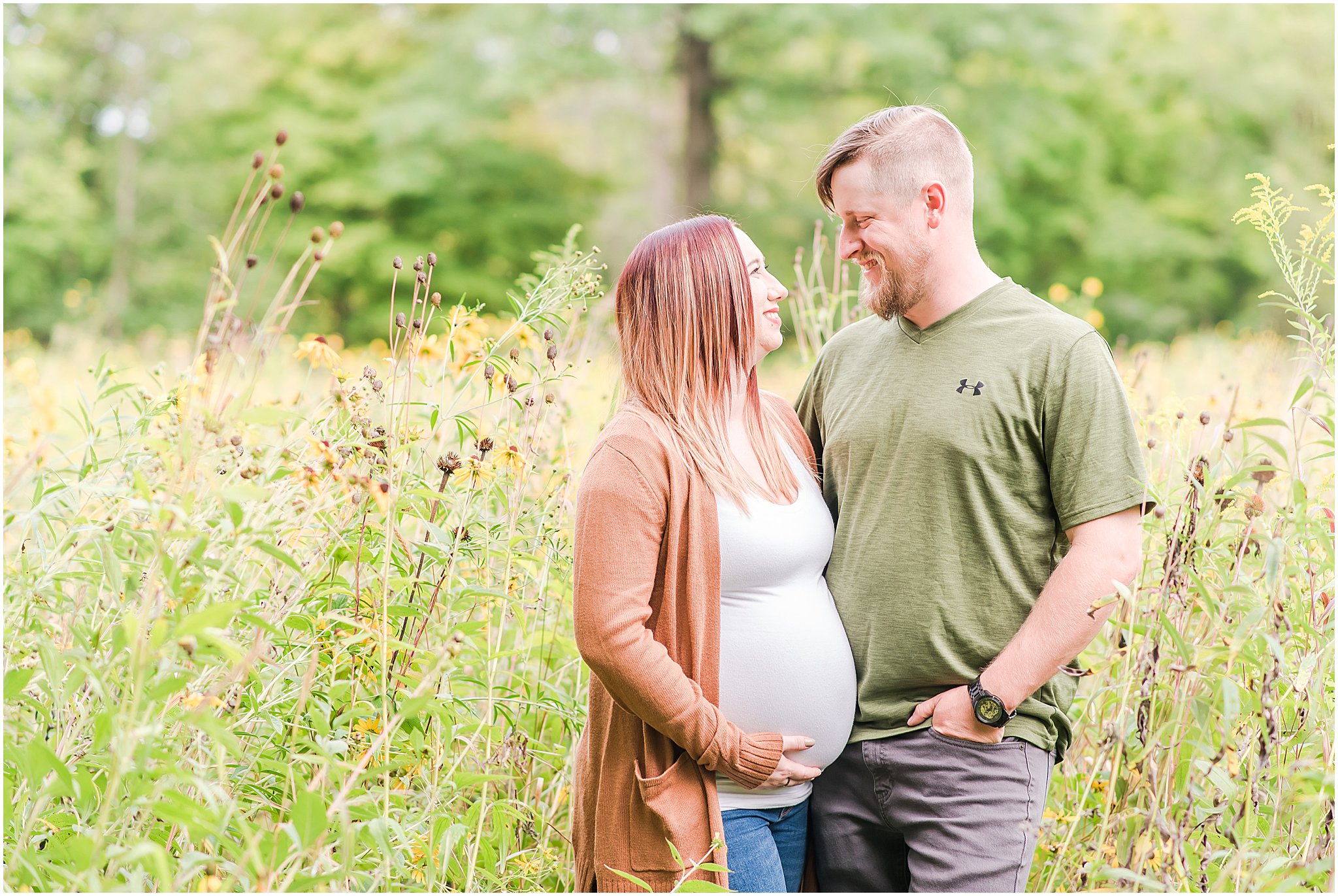 Husband and wife smiling at each other during Eagle Creek Park maternity session