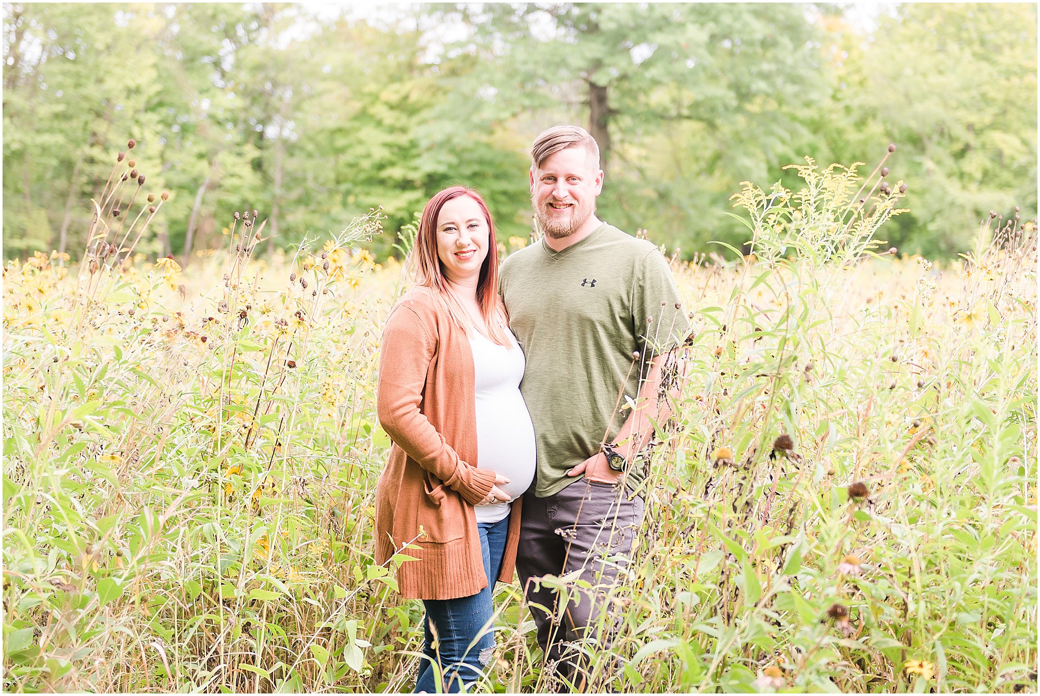 Husband and wife smiling at camera during Eagle Creek Park maternity session