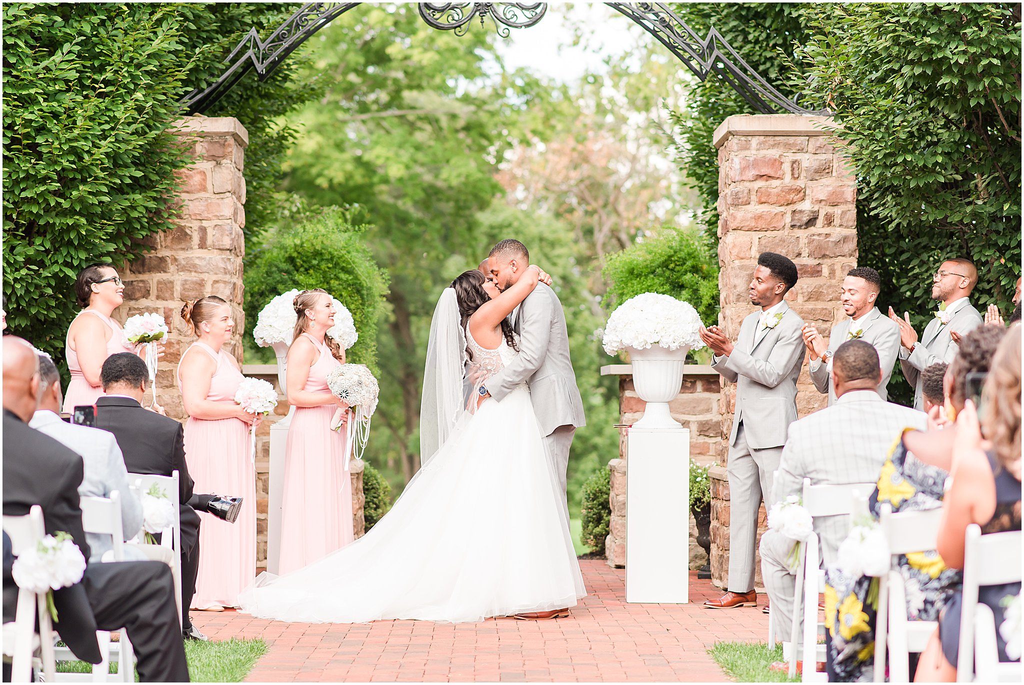 Husband and wife first kiss during outdoor ceremony at Pinnacle Golf Club | Courtney Carney Photography