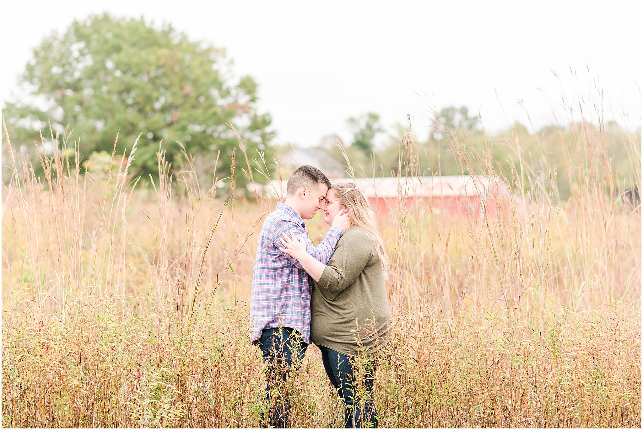 Couple nose to nose in a field during Beckley Creek Park engagement session