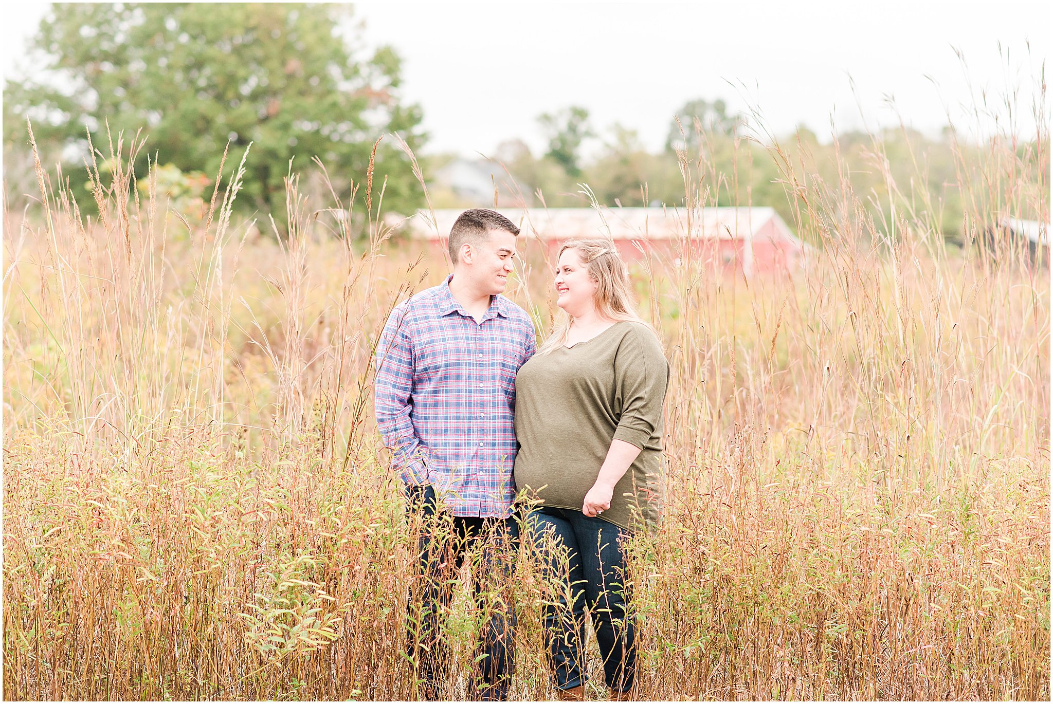 Couple smiling, holding hands and walking during Beckley Creek Park engagement session
