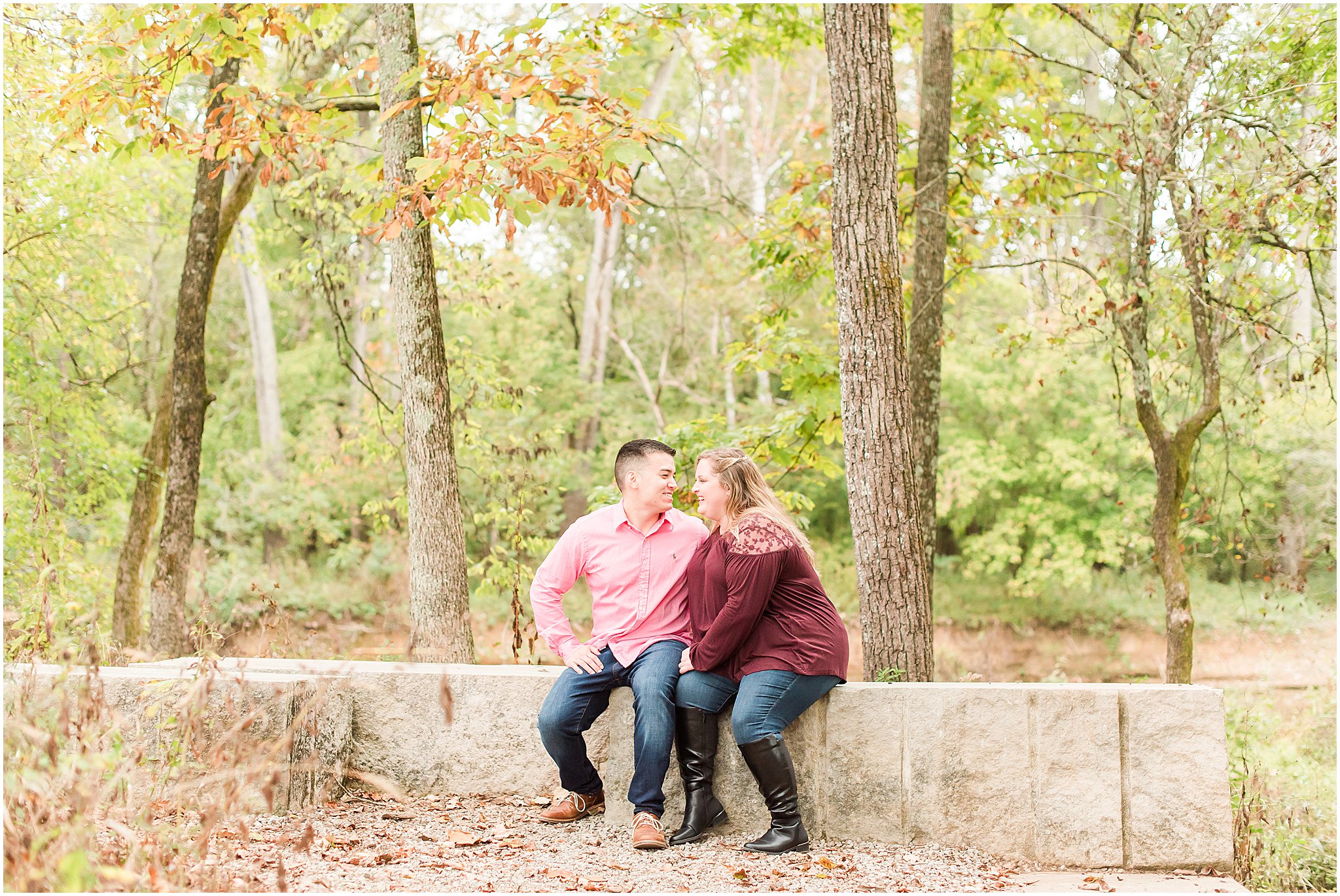 Couple sitting on bench and laughing during Beckley Creek Park engagement session