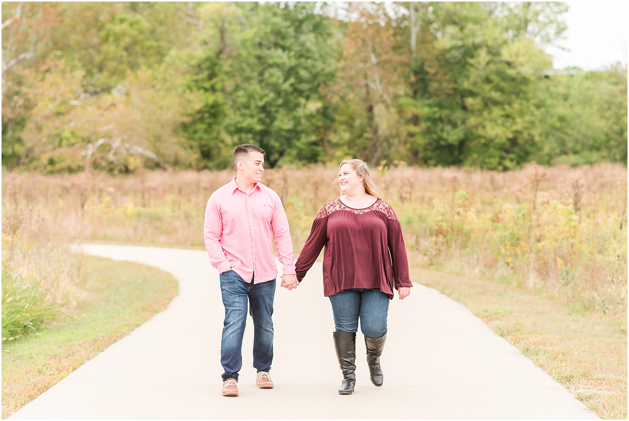 Couple holding hands and walking during Beckley Creek Park engagement session