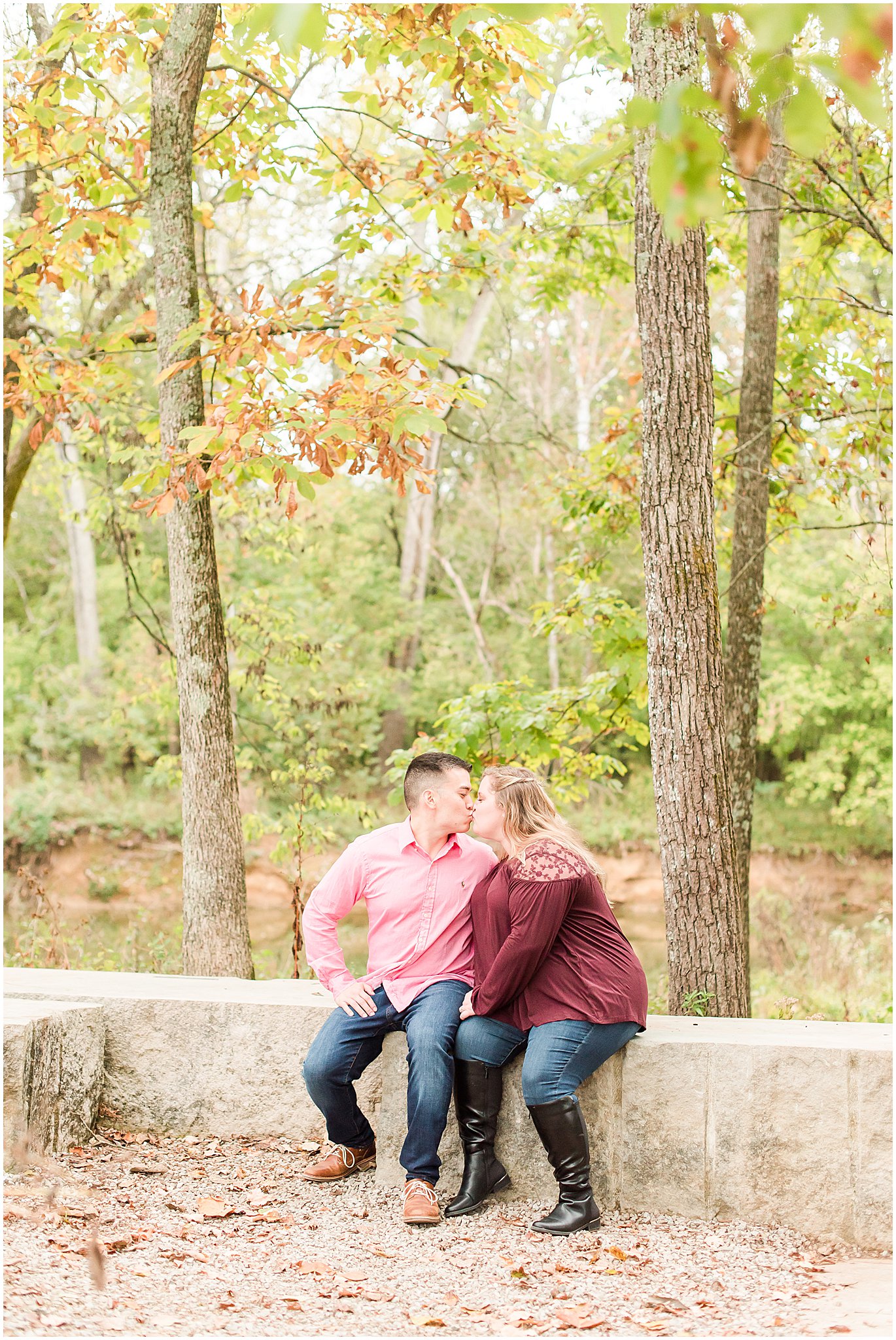 Couple sitting and kissing during Beckley Creek Park engagement session