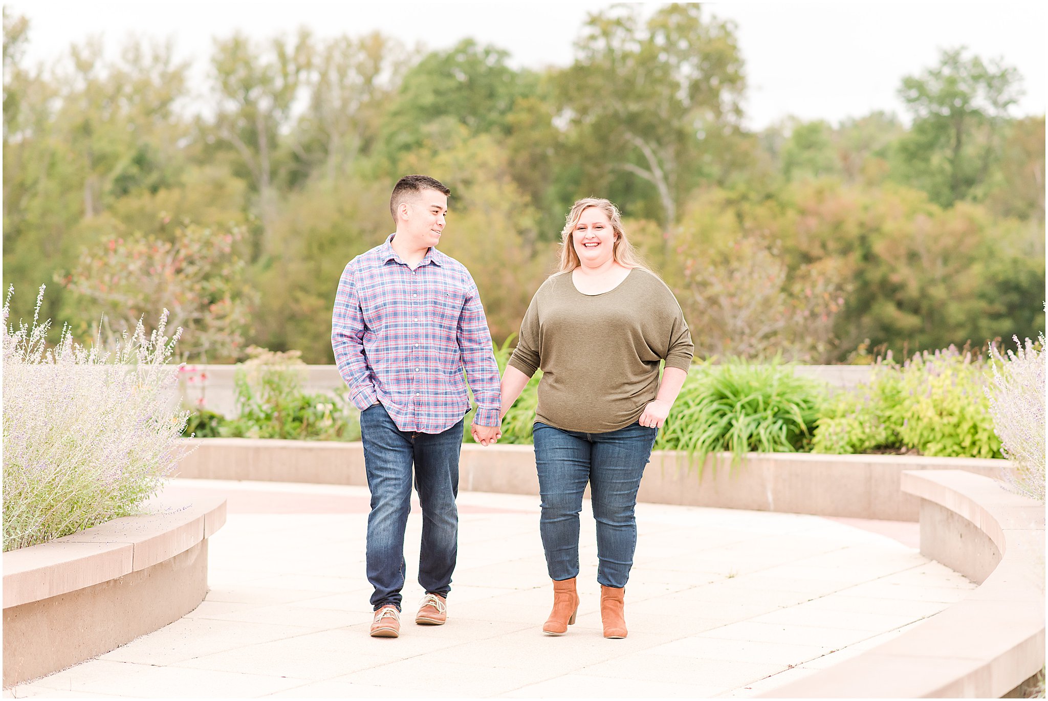 Couple holding hands, laughing during Beckley Creek Park engagement session