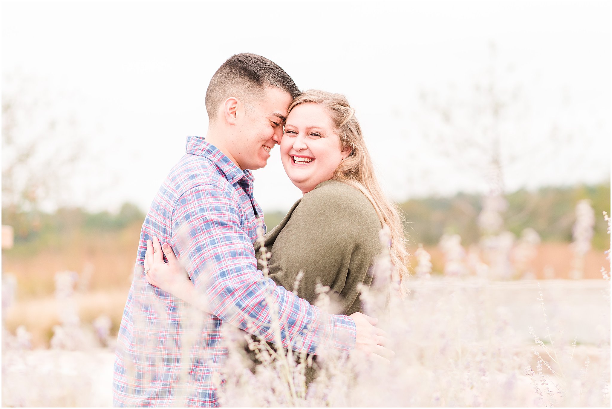 Couple laughing as they nuzzle during Beckley Creek Park engagement session