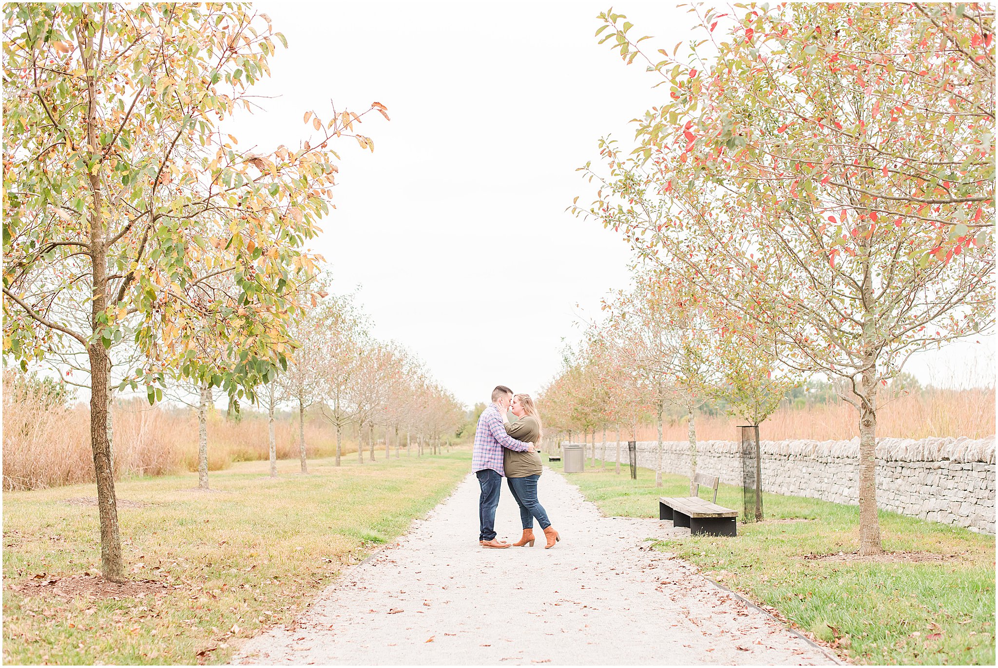 Couple nose to nose along tree line during Beckley Creek Park engagement session