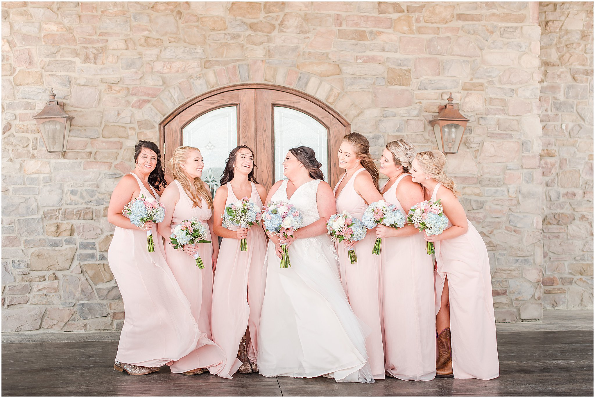 Bride laughing with bridesmaids at Cornerstone Hall in Salem, IN