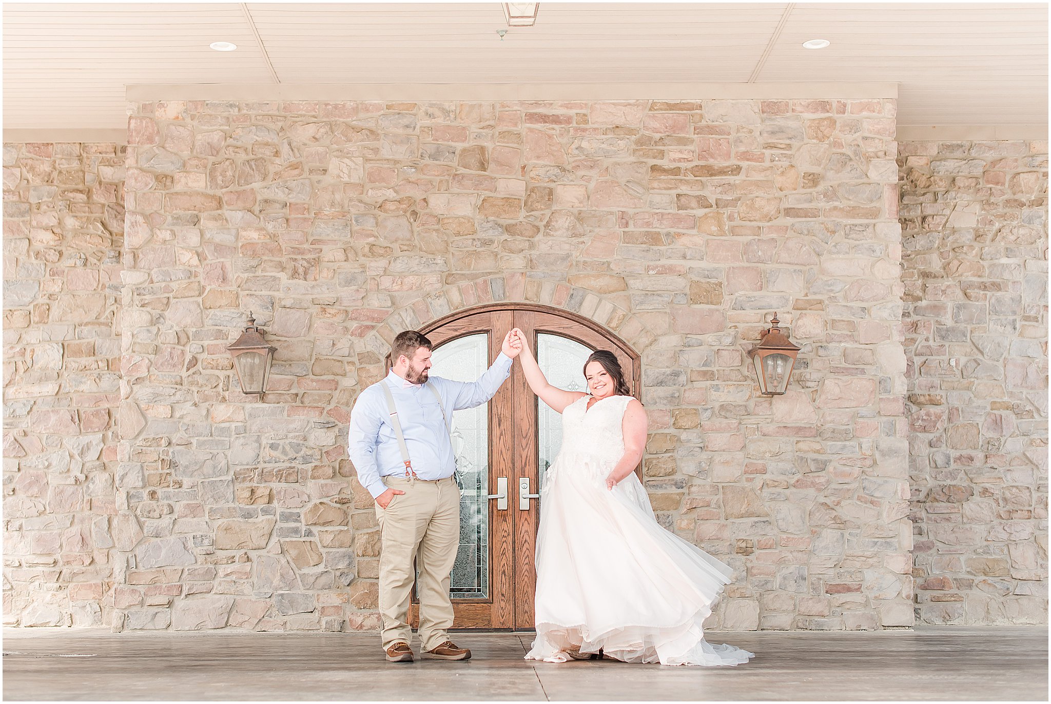 Bride twirling with groom outside Cornerstone Hall in Salem, IN