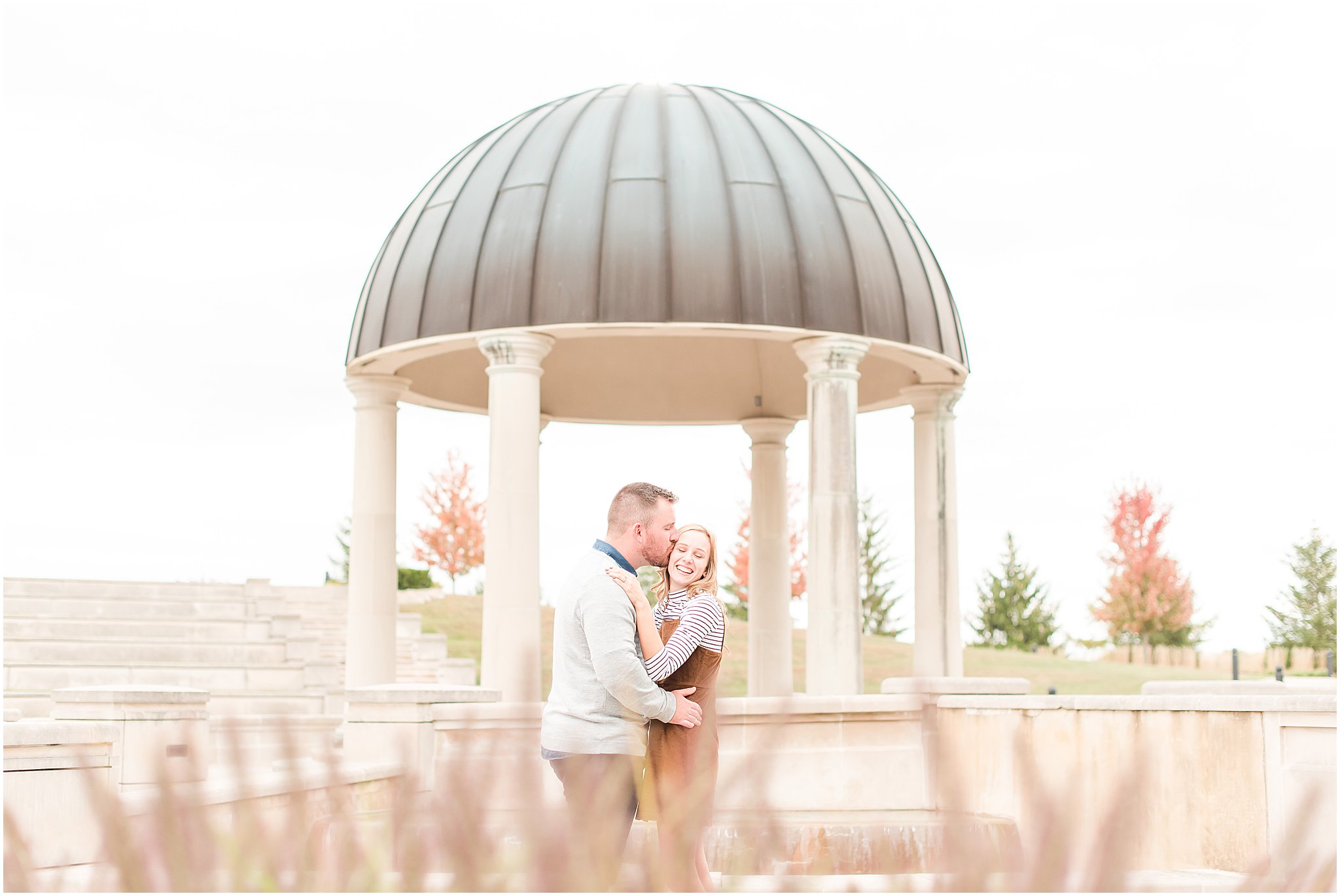 Couples nuzzling and laughing during Coxhall Gardens engagement session