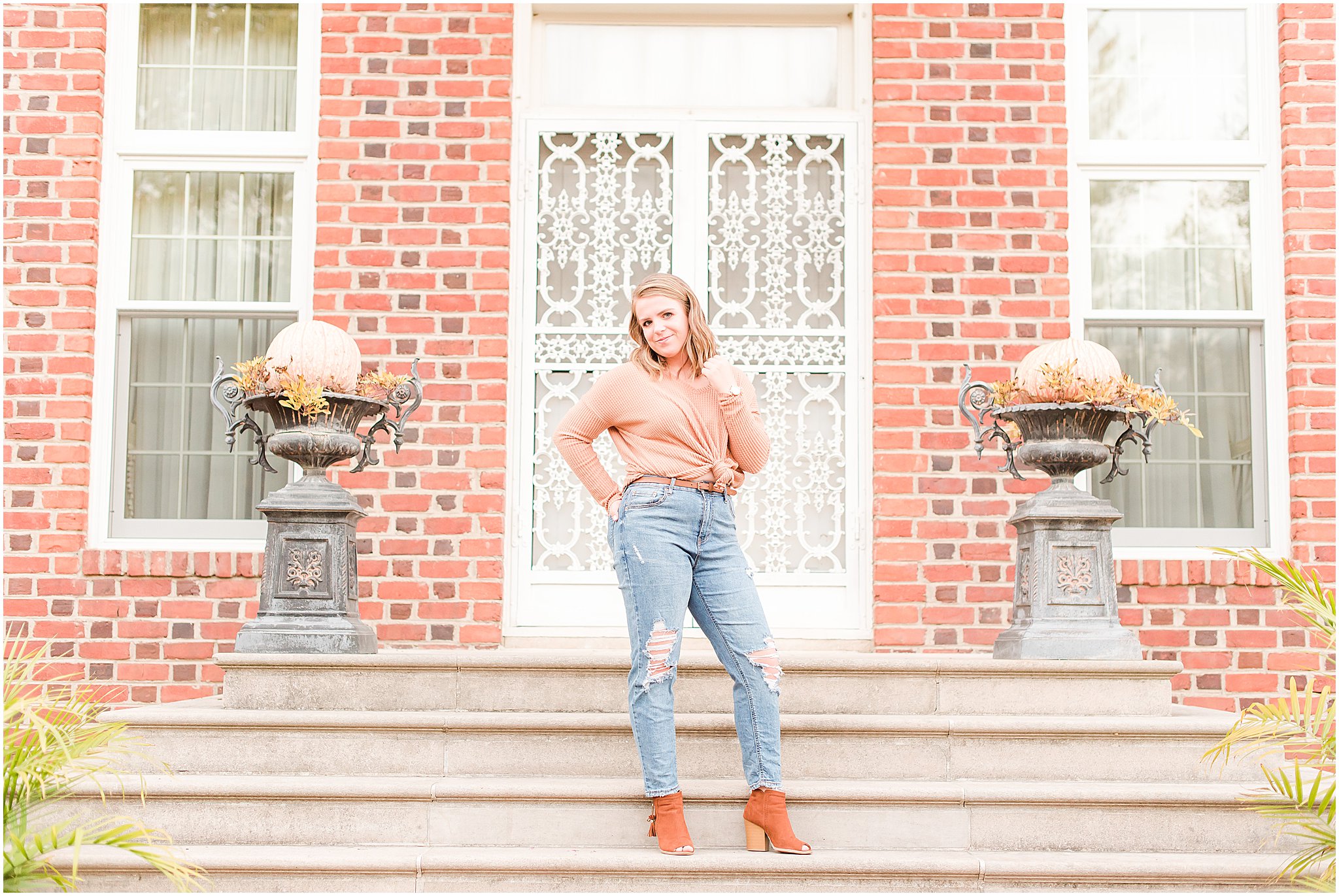 Girl standing in front of mansion during Coxhall Gardens senior session