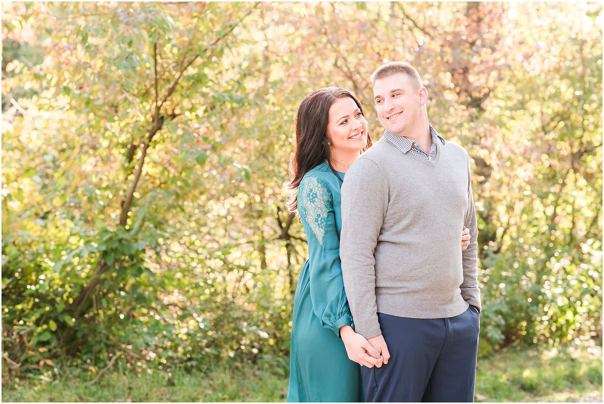 Couple holding hands and smiling at each other during Eagle Creek Park couples session