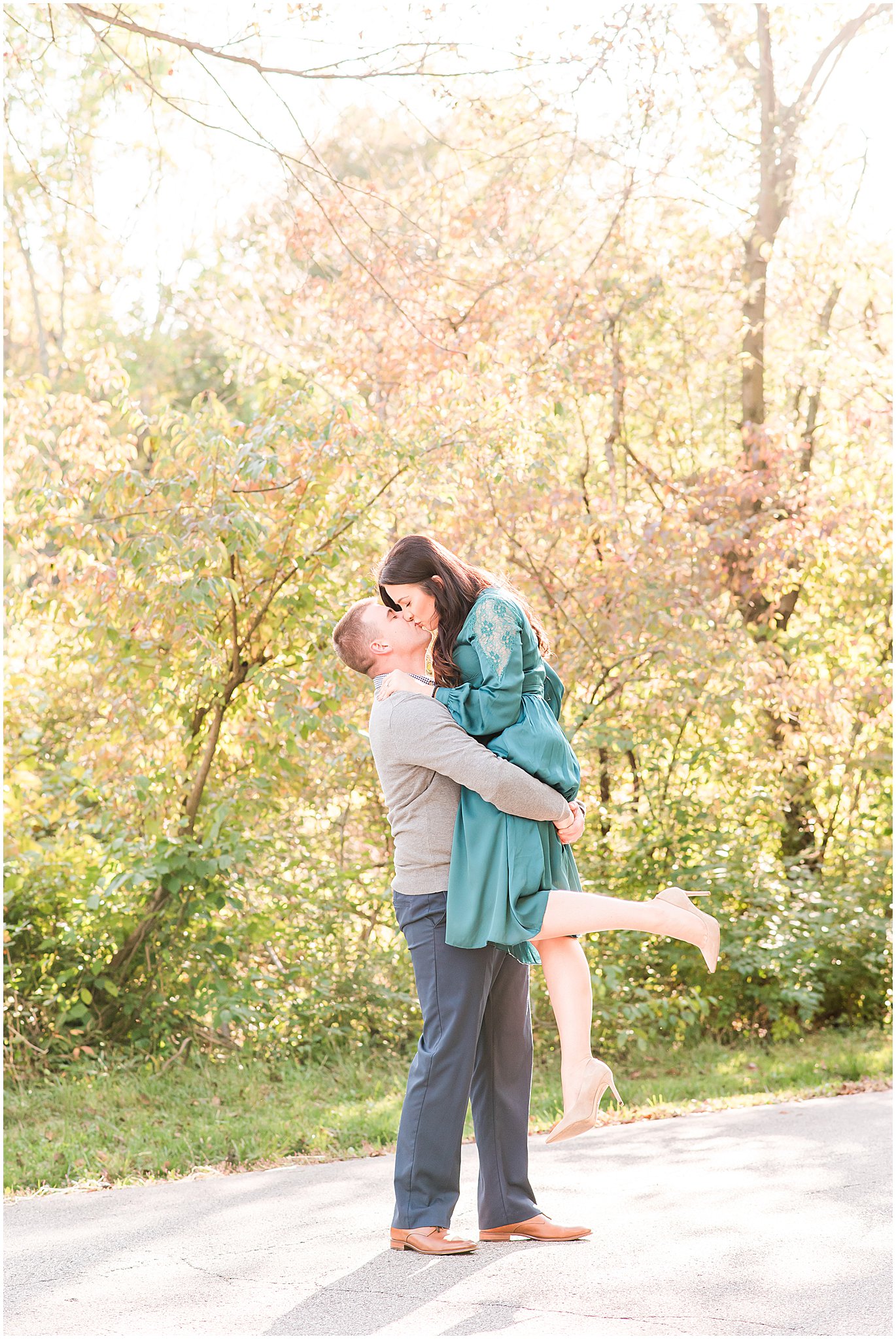 Guy lifting girl as they kiss during Eagle Creek Park couples session