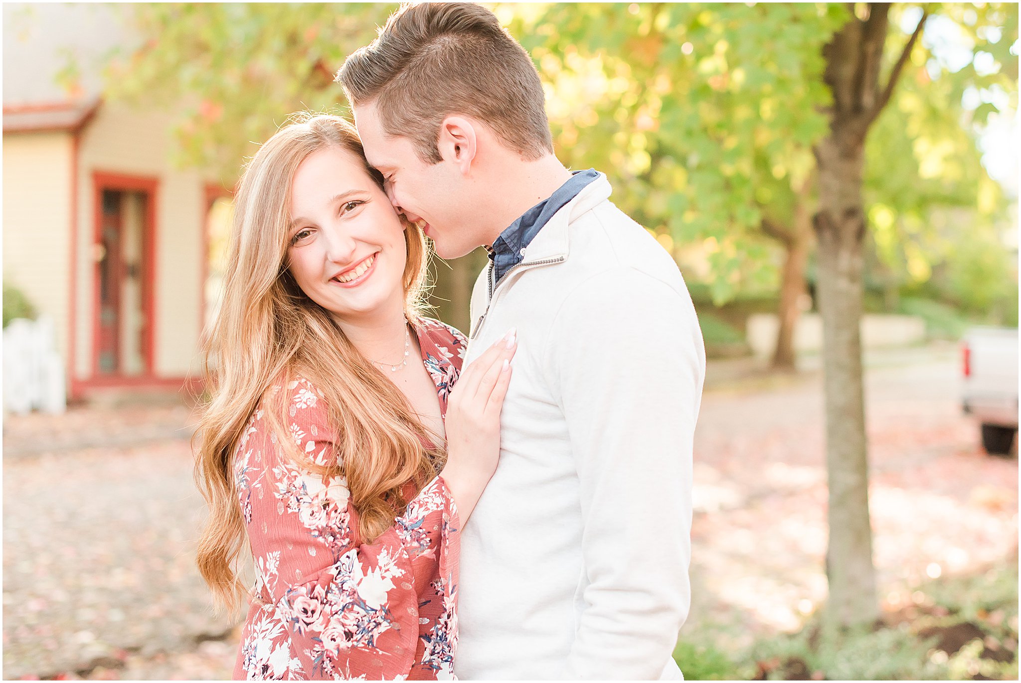 Couple nuzzling and smiling during Lockerbie Square engagement session