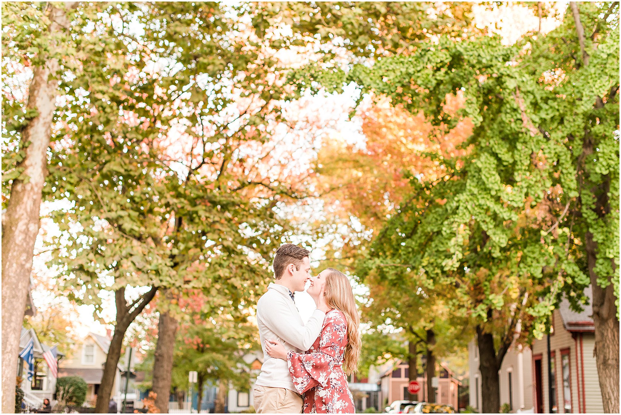 Couple kissing on cobblestone street during Lockerbie Square engagement session
