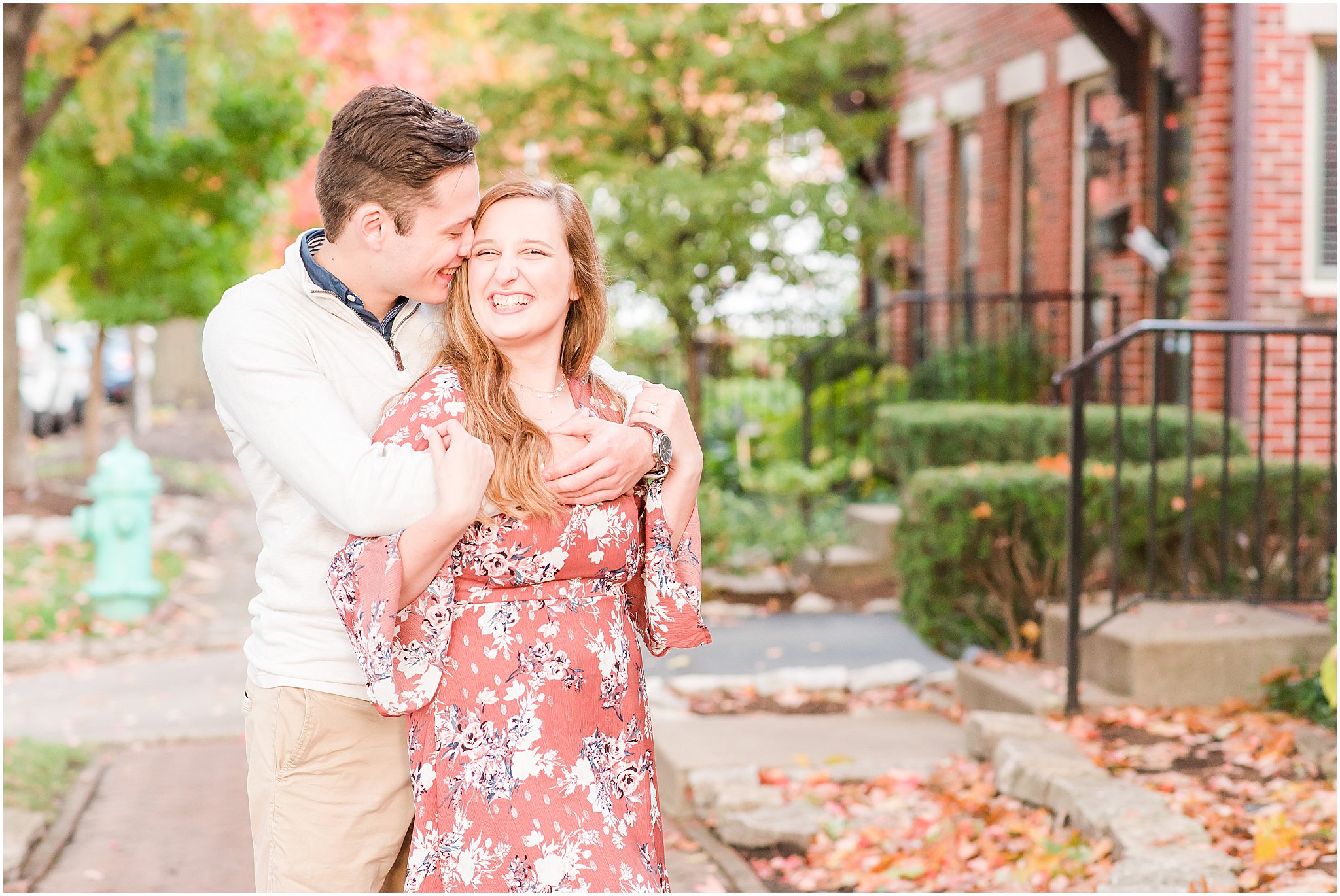 Couple nuzzling and laughing during Lockerbie Square engagement session