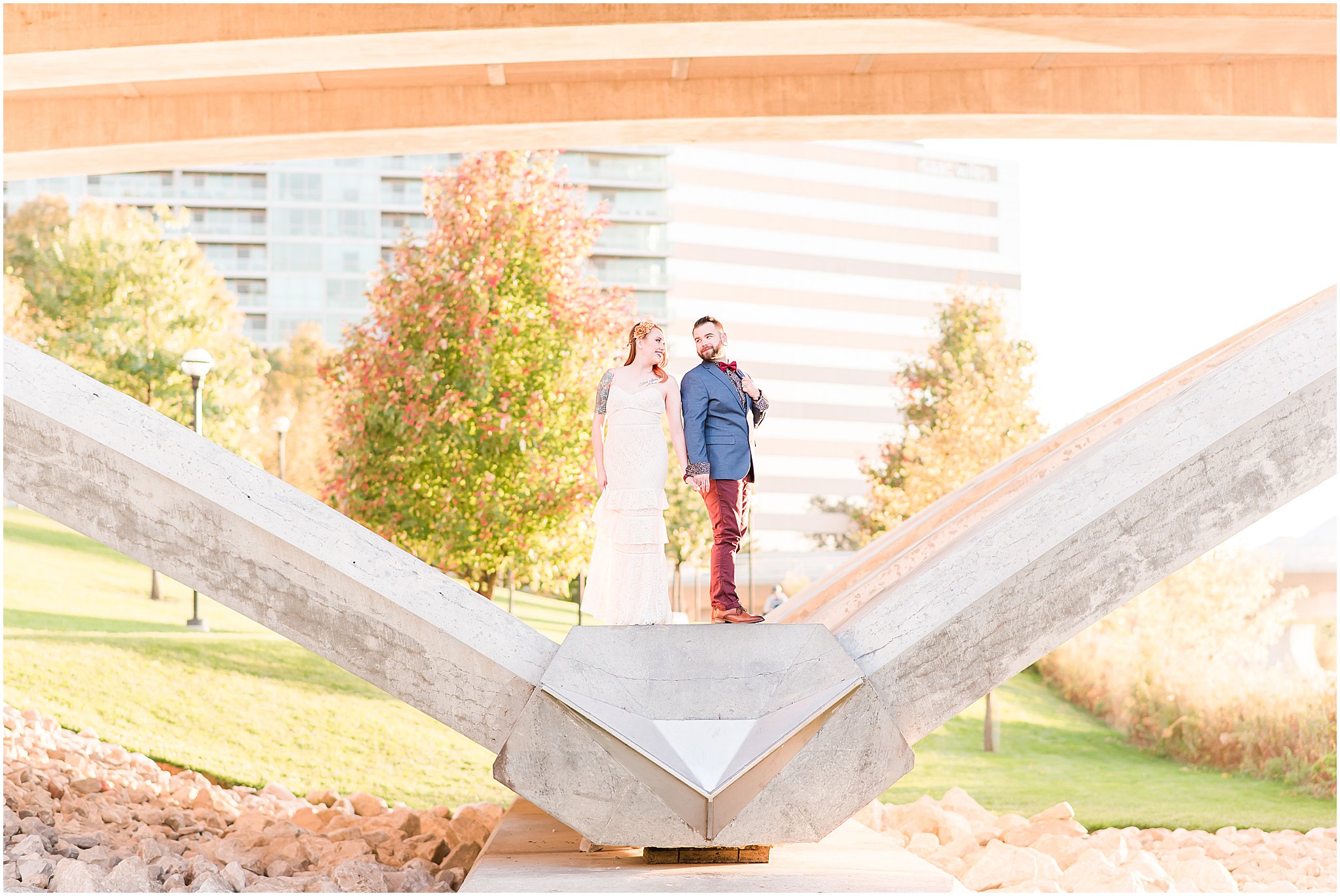 Couple smiling over shoulders at each other during Scioto Mile engagement session
