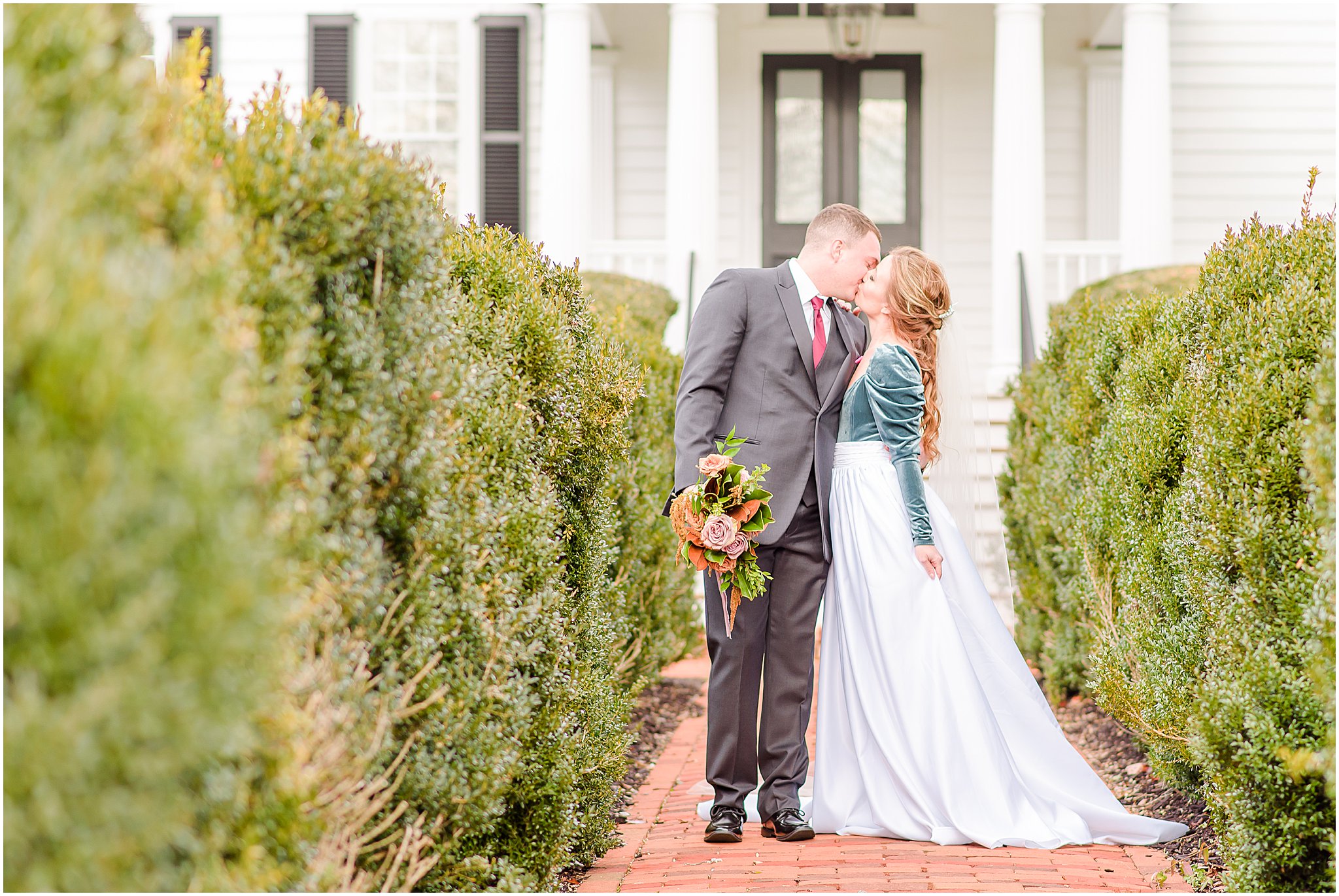 Bride and groom kissing in front of Mount Ida Mansion Mount Ida Farm wedding