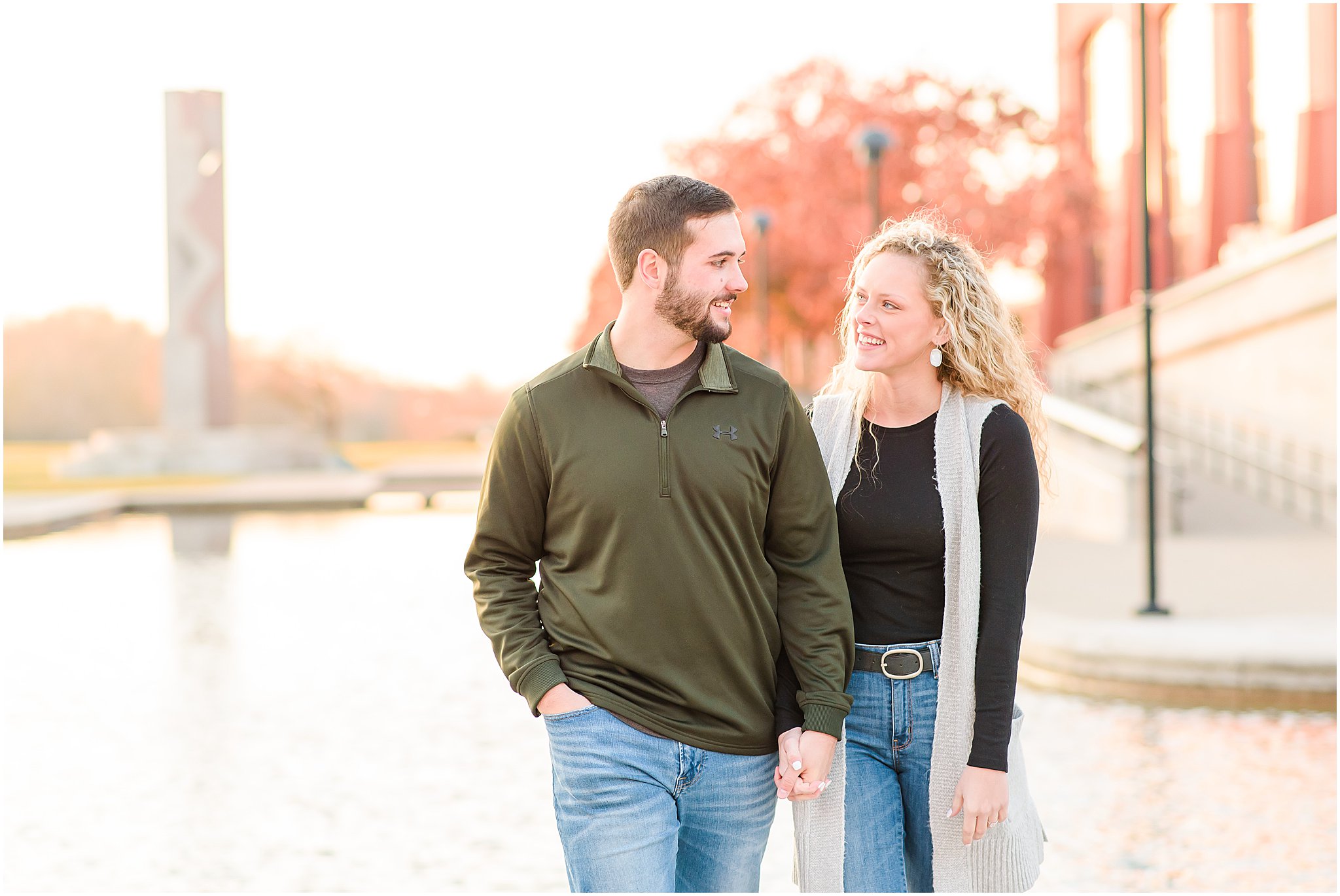 Couple holding hands in front of canal during Indianapolis Canal Engagement Session