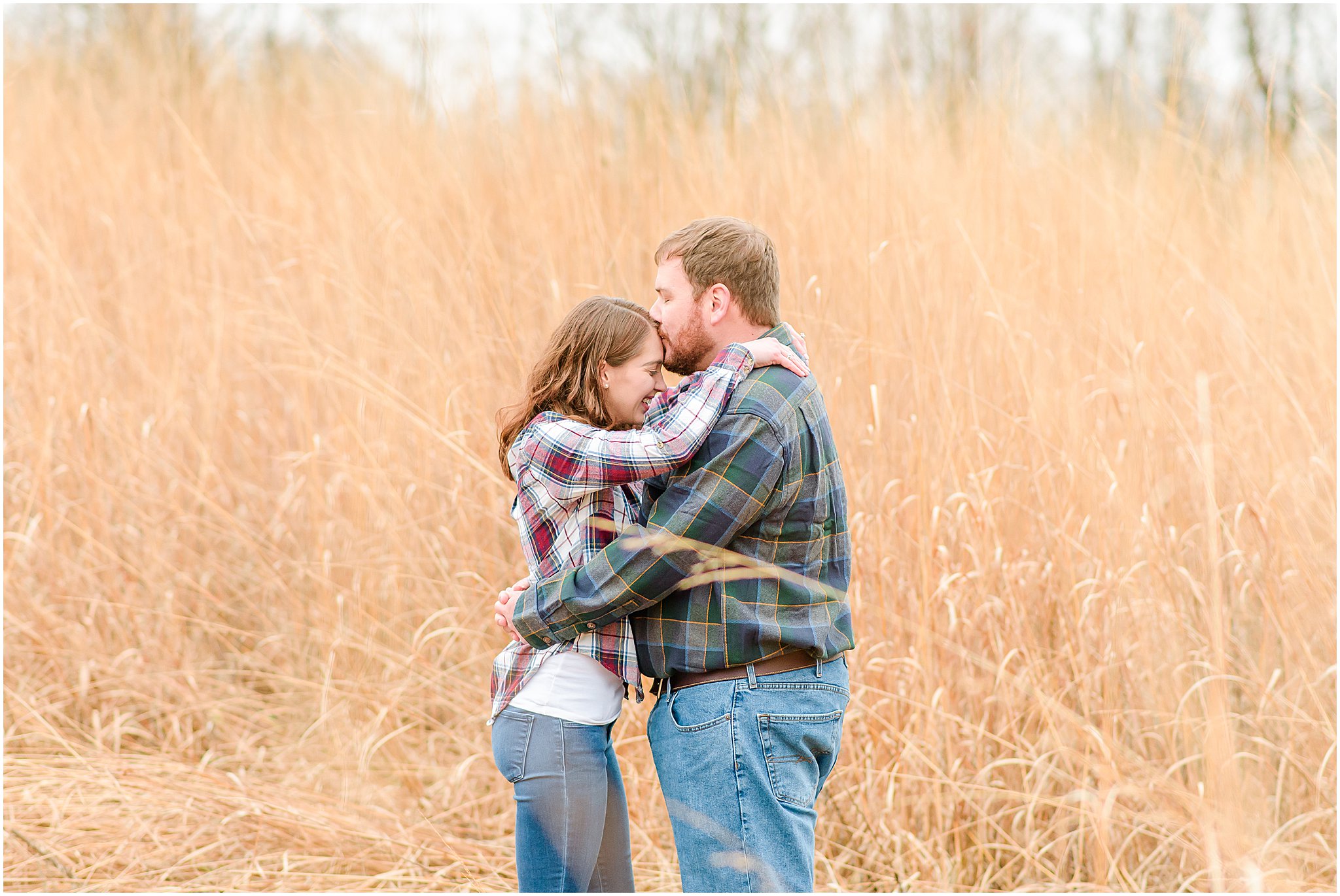 Guy kissing girl's forehead during Eagle Creek Park engagement session