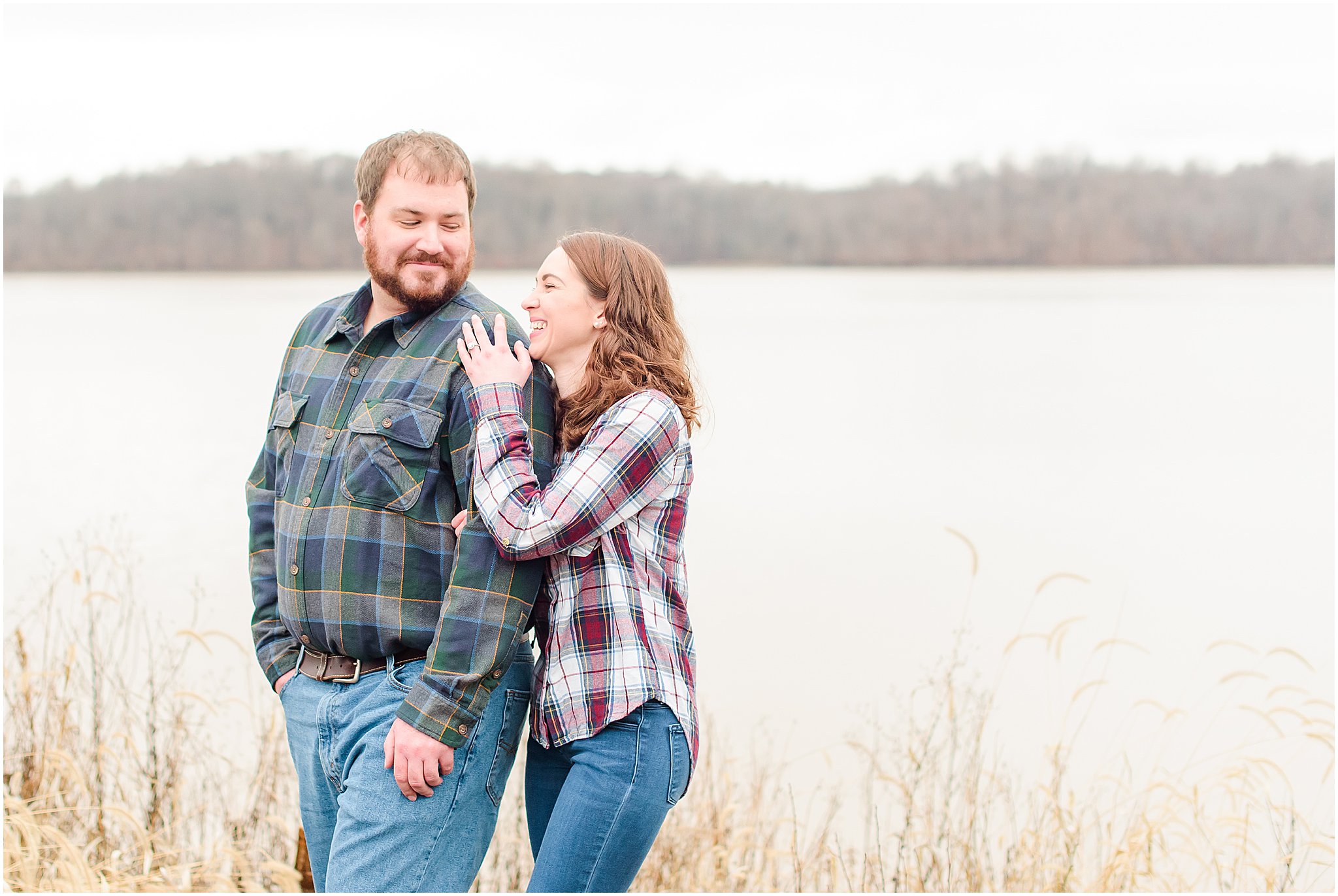 Couple holding hands and laughing at each other during Eagle Creek Park engagement session