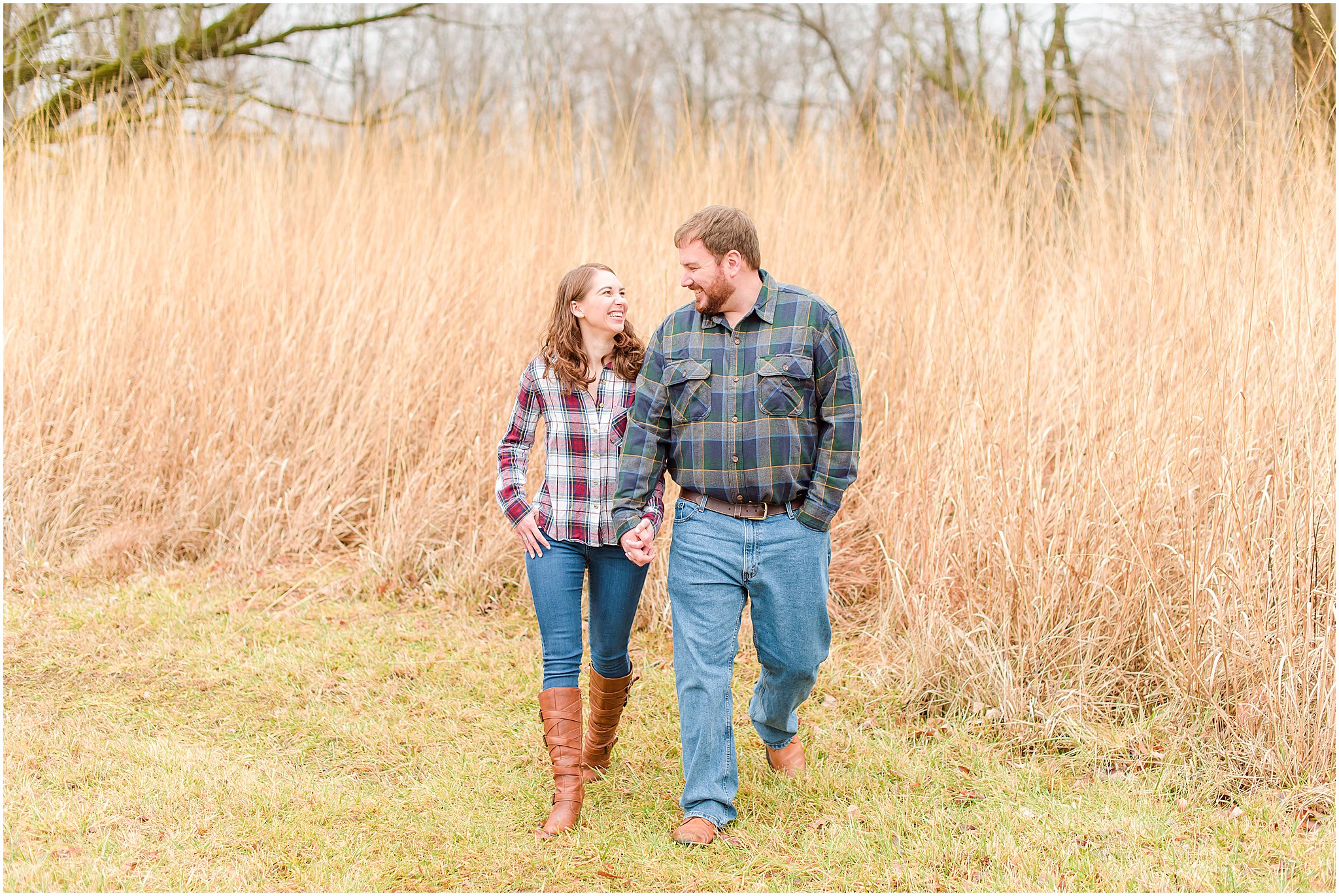 Couple holding hands and walking towards camera during Eagle Creek Park engagement session