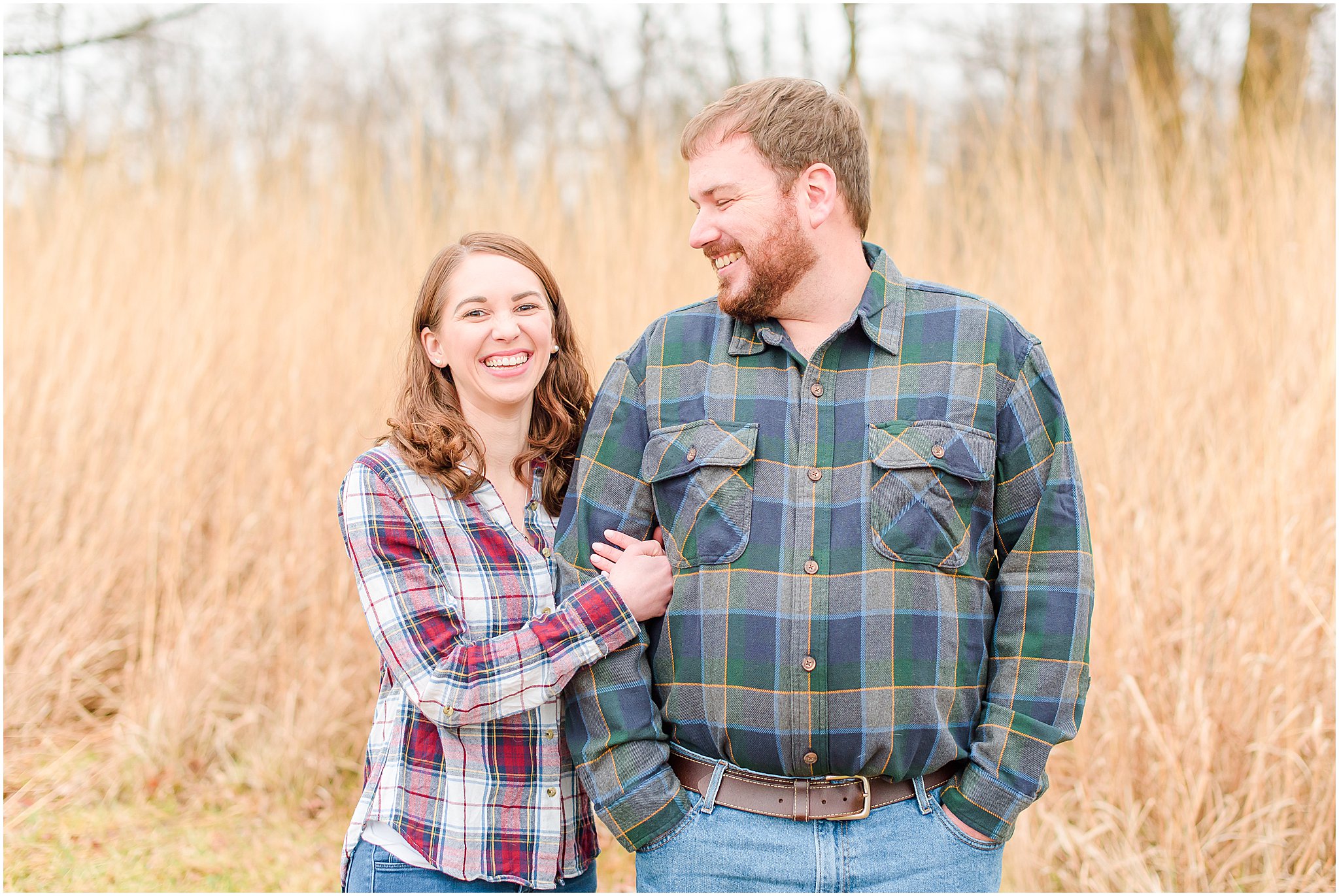 Couple standing side by side and smiling during Eagle Creek Park engagement session