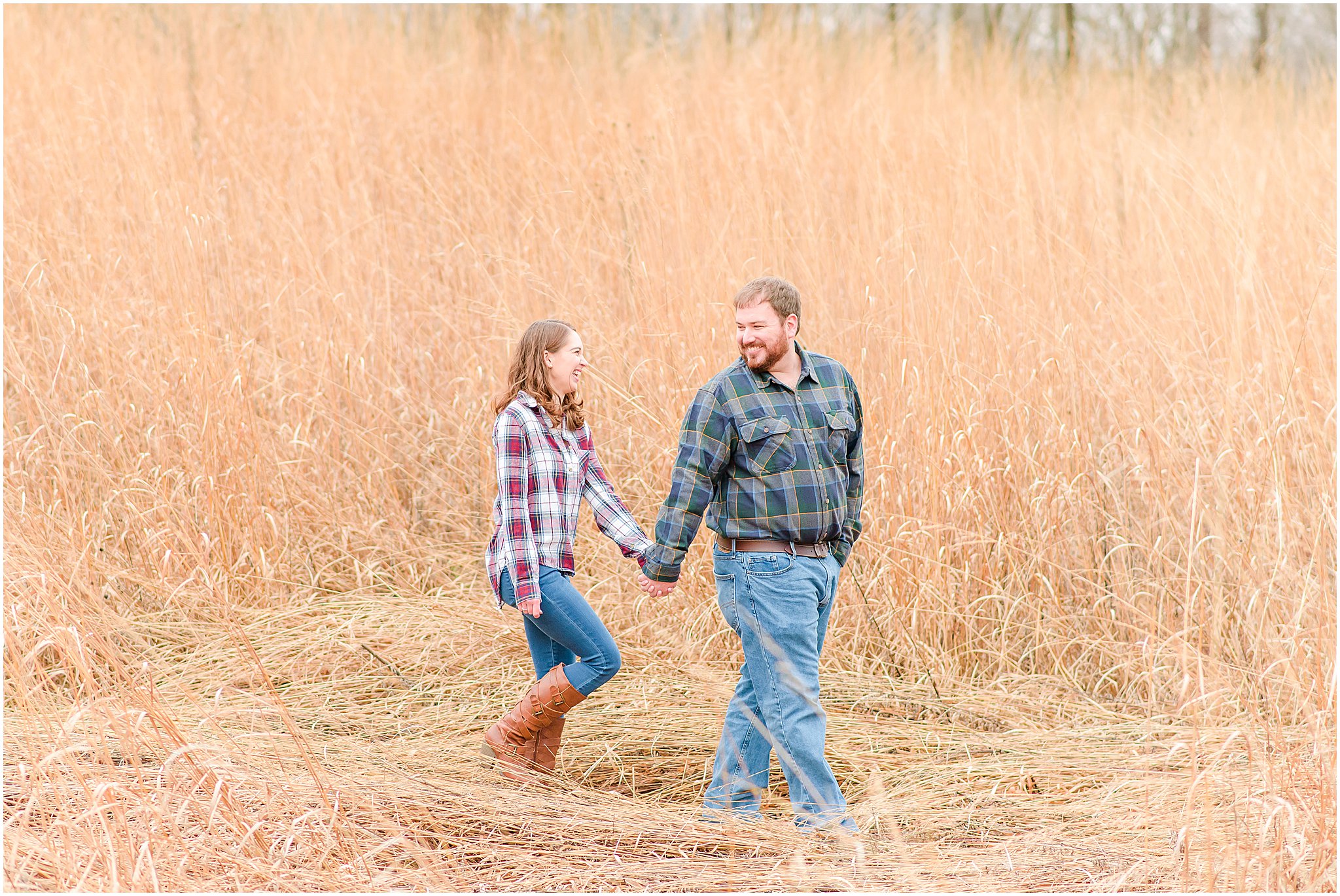 Couple holding hands and walking during Eagle Creek Park engagement session