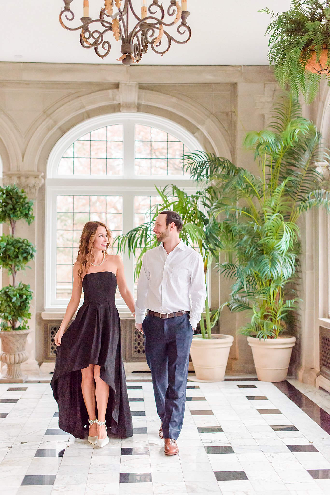 Couple holding hands and walking during Laurel Hall Engagement Session