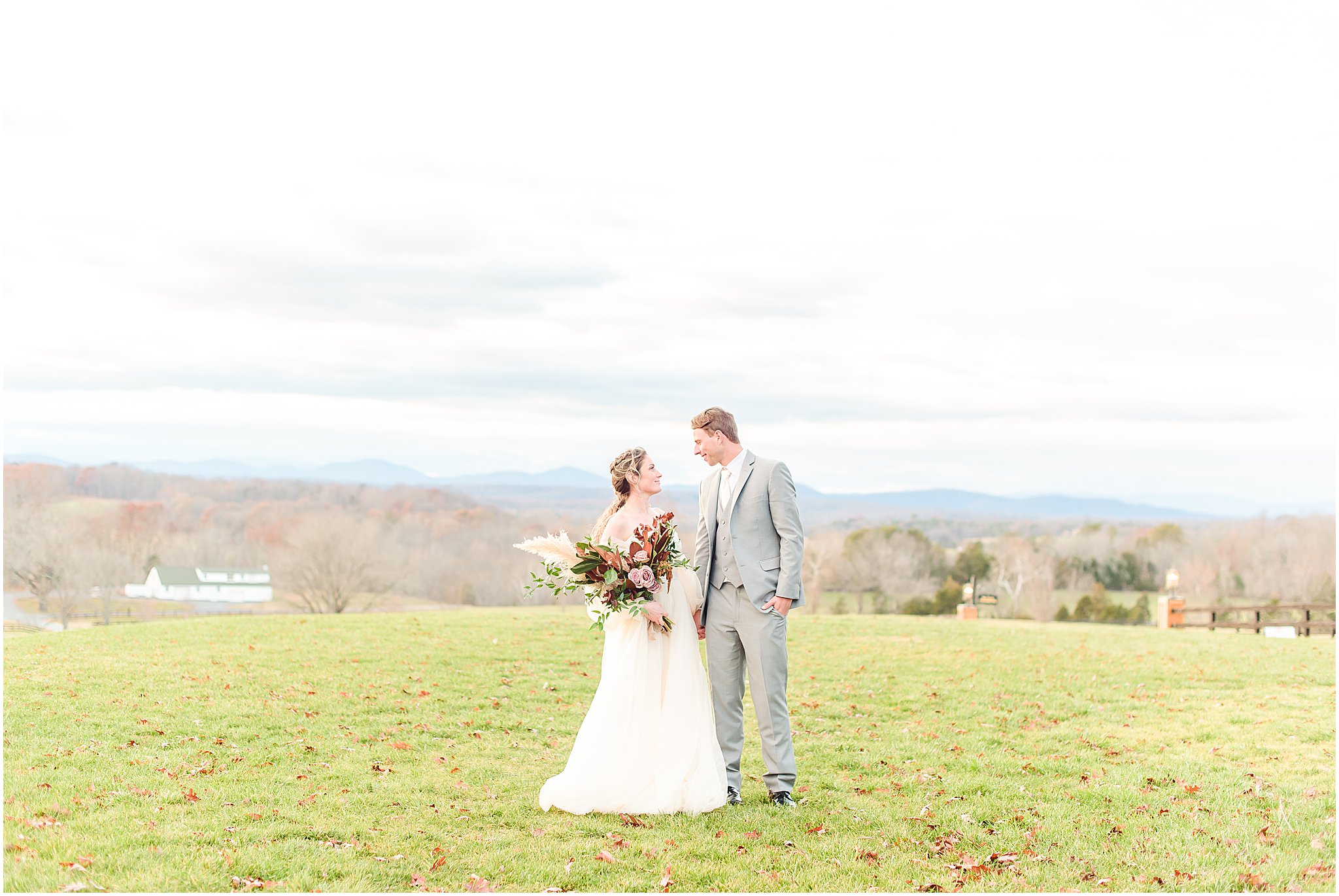 Bride and groom smiling at each other with mountains in background Mount Ida Farm Wedding