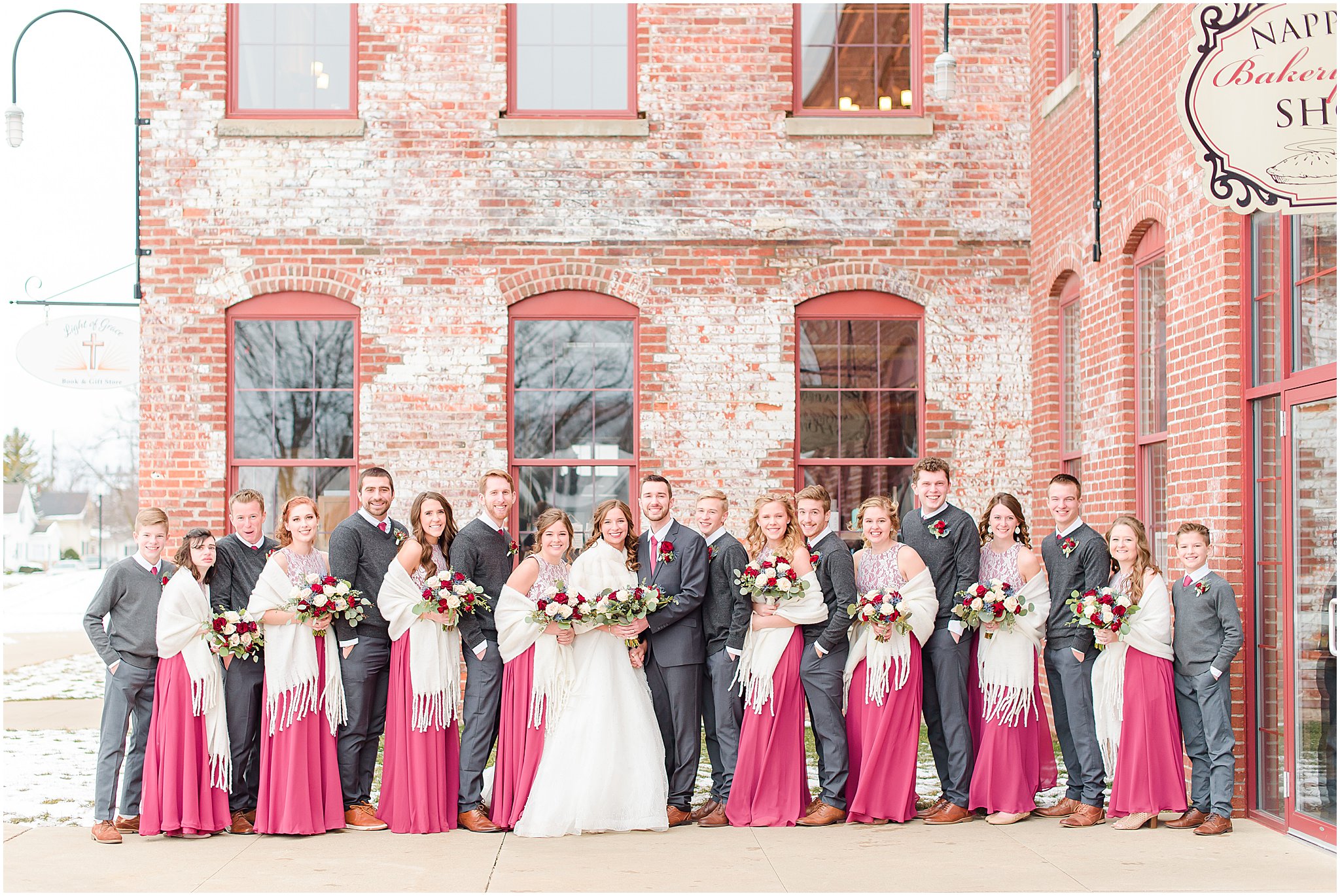 Bridal party smiling at camera outside Coppes Commons Wedding