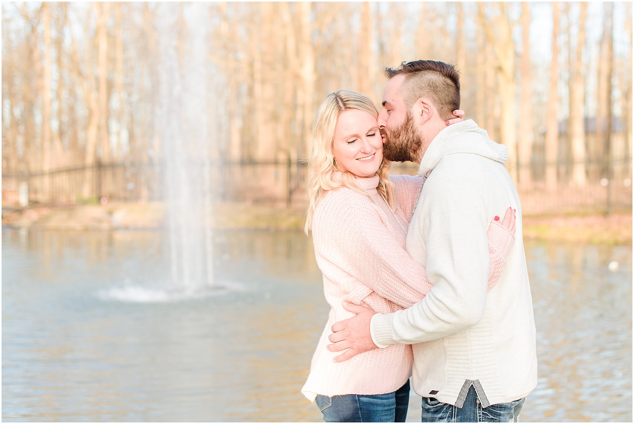 Groom kissing bride's cheek in front of pond Lizton Lodge Engagement Session