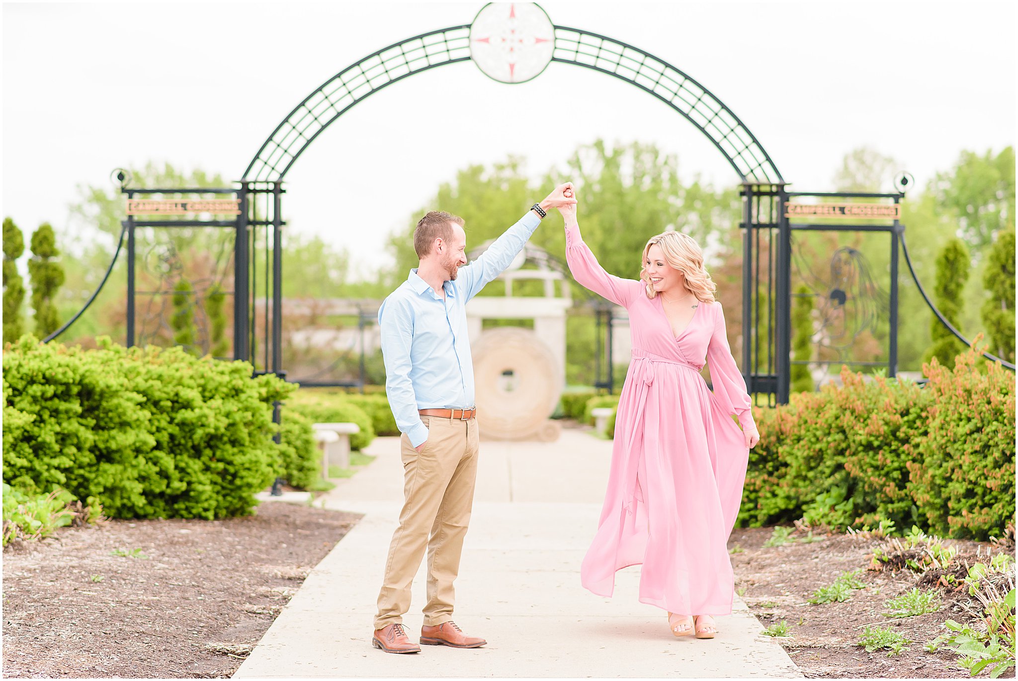 Couple twirling during Coxhall Gardens engagement session