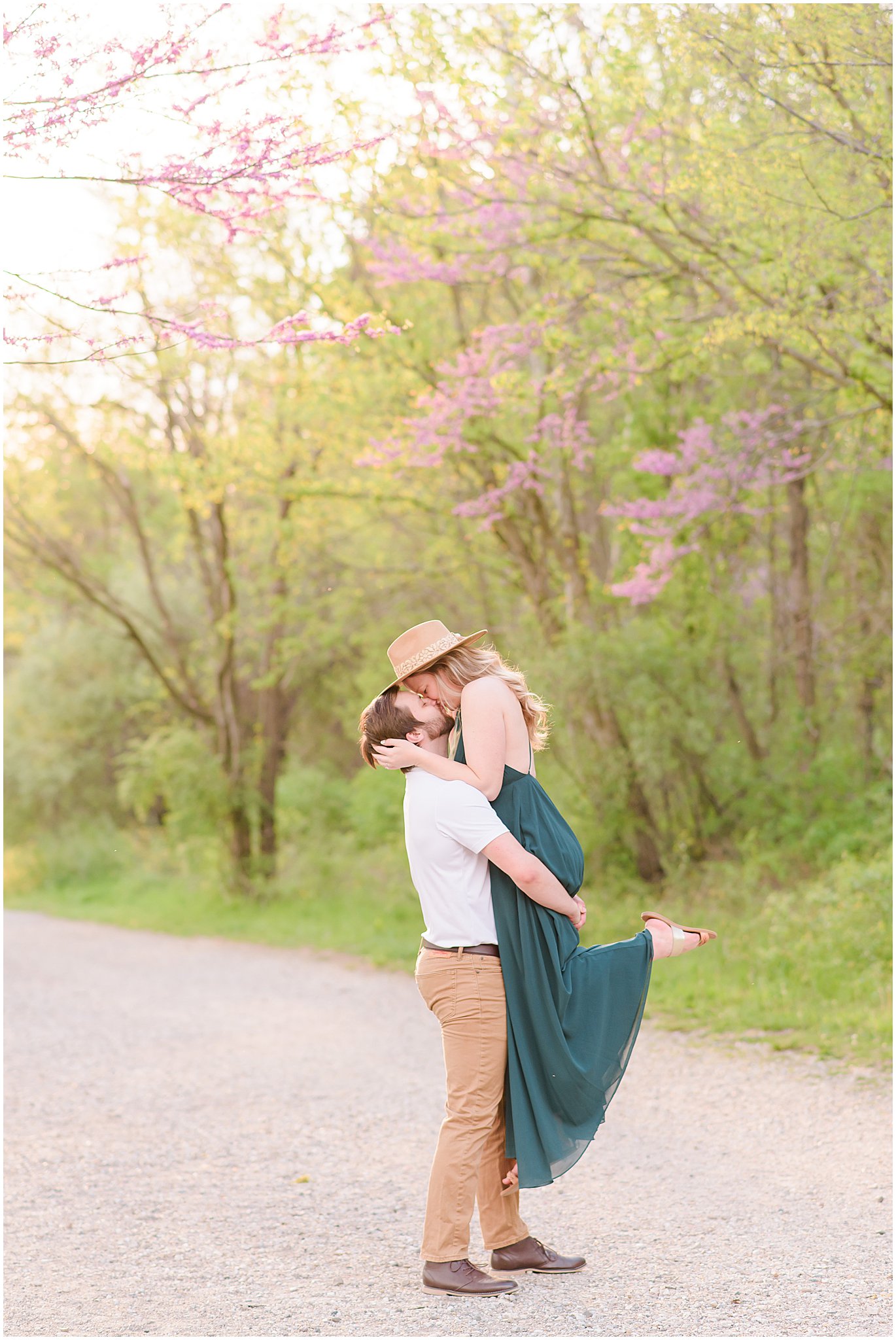 Couple lift kiss during Eagle Creek Park Engagement Session
