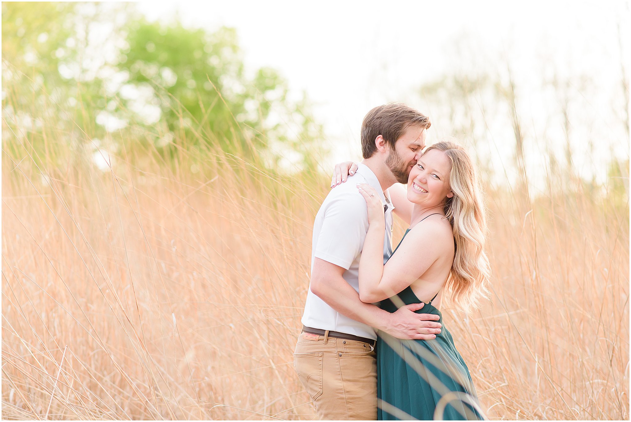 Guy kissing girl on cheek during Eagle Creek Park Engagement Session