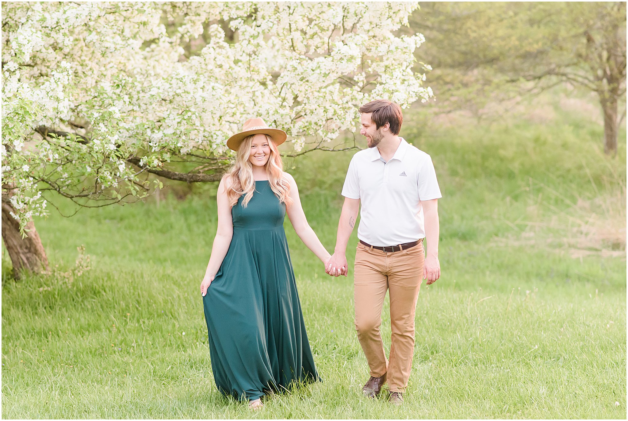 Couple walking and holding hands during Eagle Creek Park Engagement Session