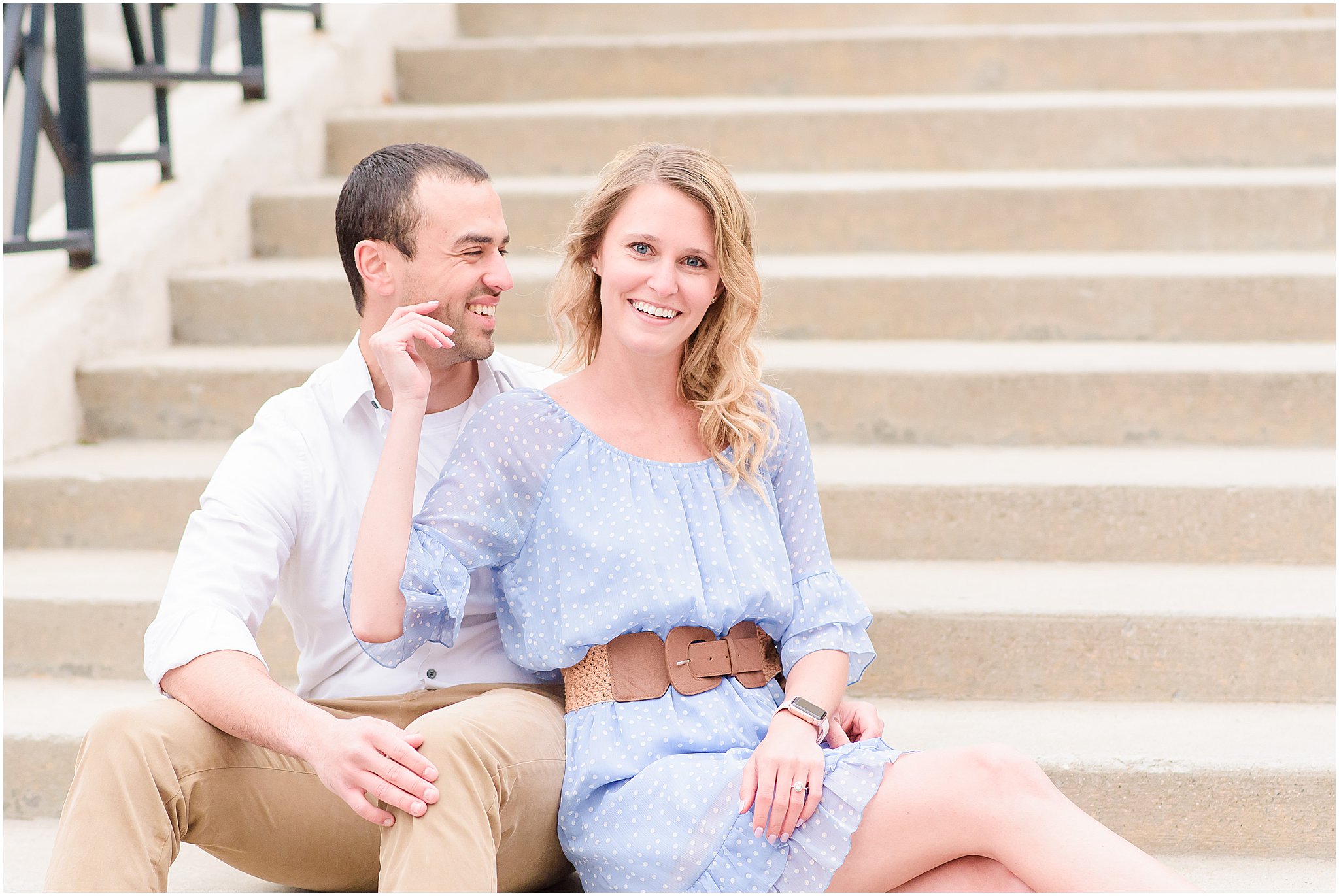 Couple sitting and smiling during Indianapolis Canal engagement session 