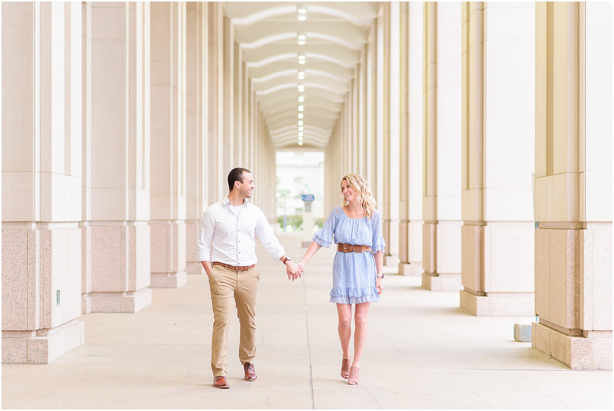 Couple holding hands and walking during Indianapolis Canal engagement session 