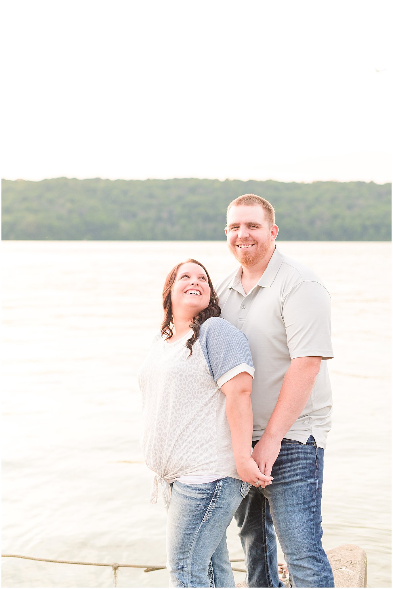 Couple smiling at each other during Brookville Lake engagement session