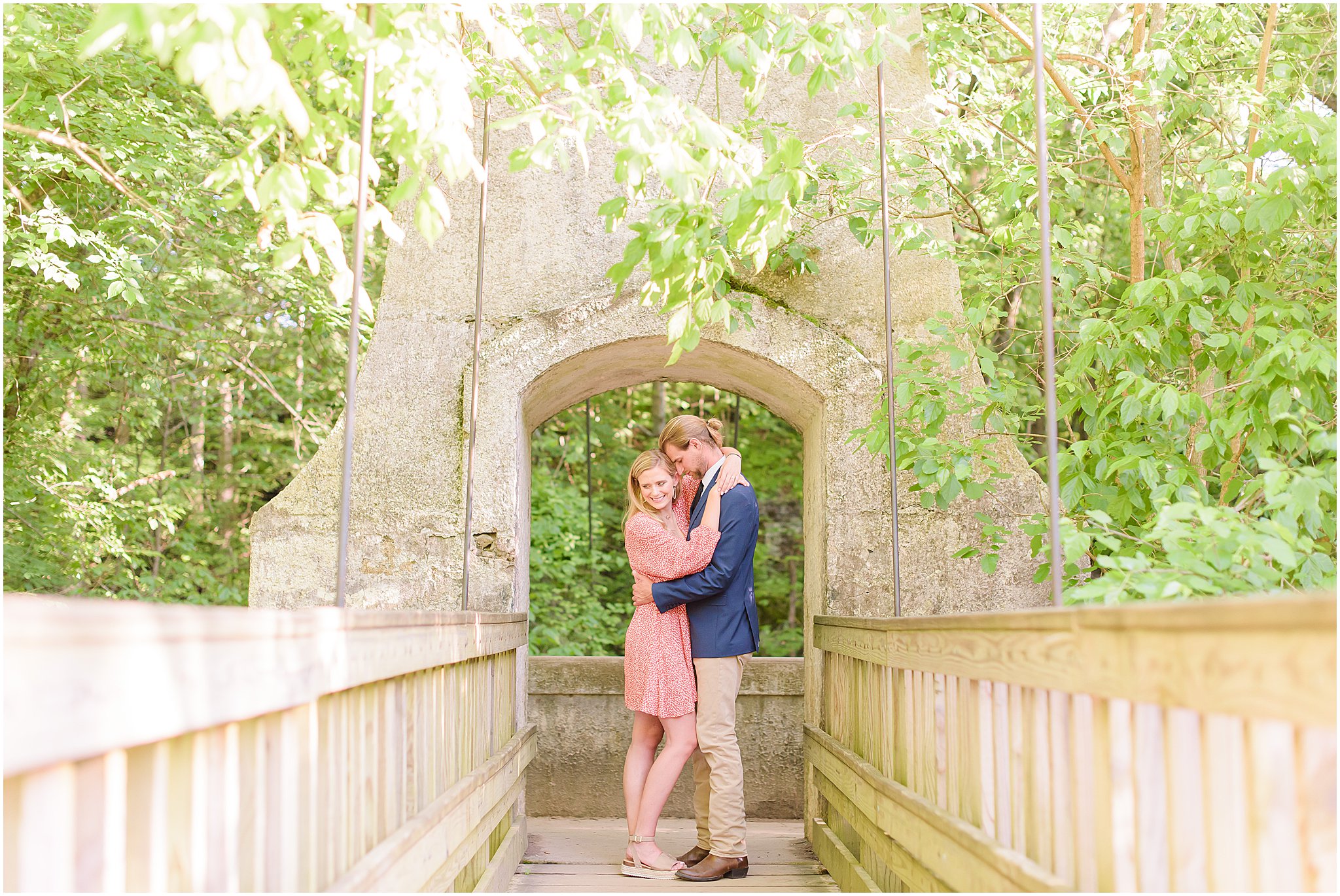 Couple nuzzling standing on bridge during Turkey Run State Park engagement session