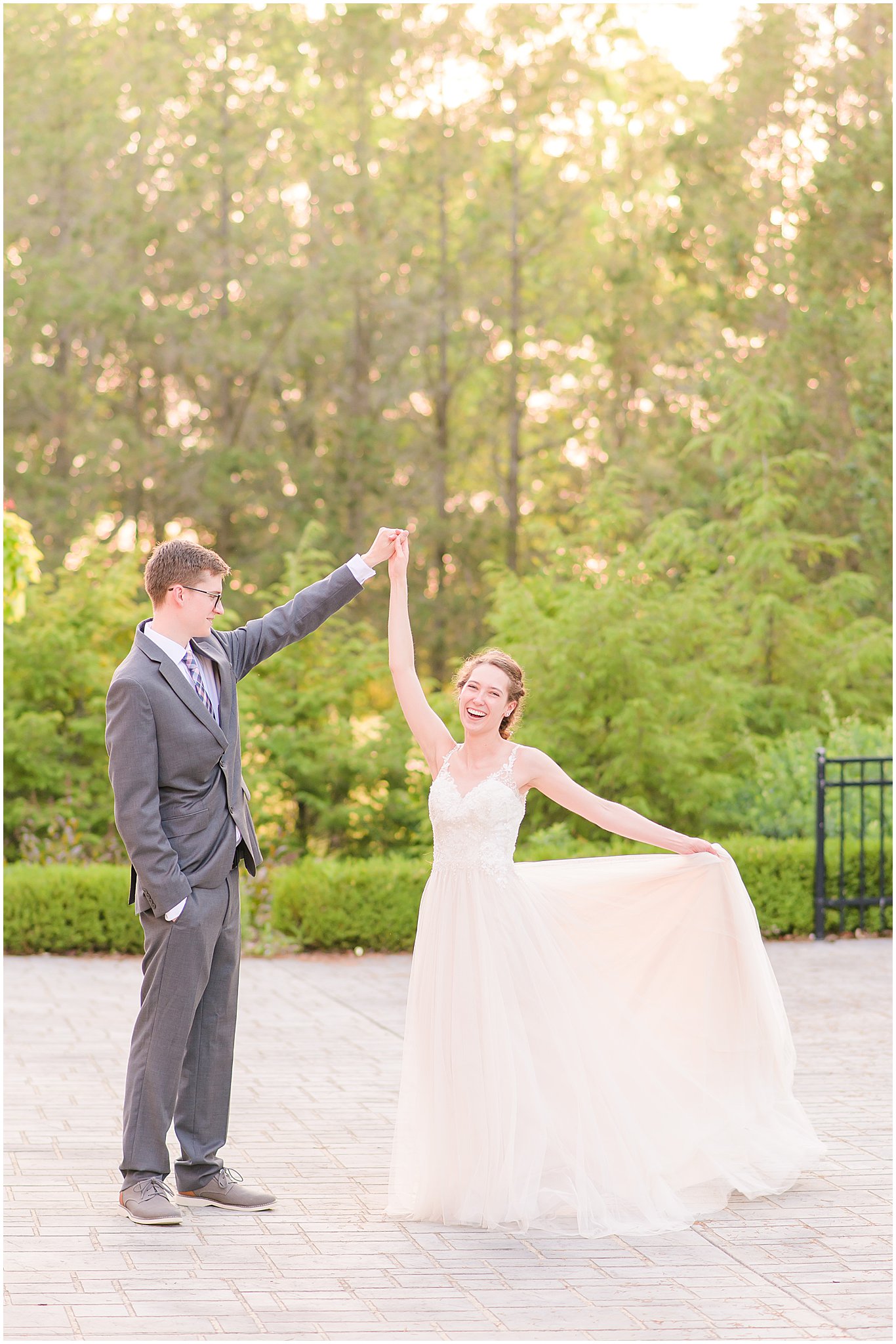 Bride laughing and twirling dress during Coxhall Gardens wedding