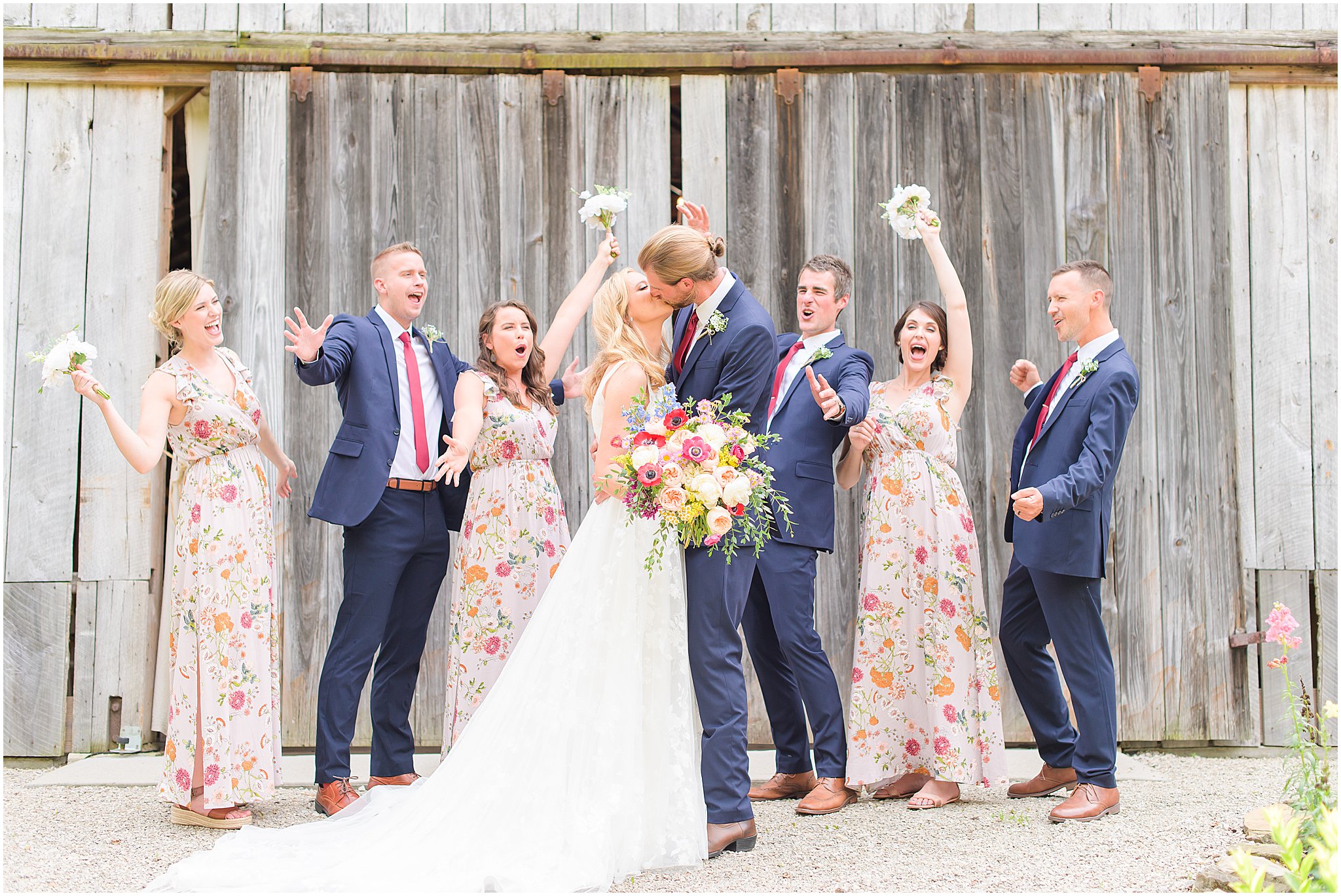 Bridal party cheering as bride and groom kiss The Old Barn At Brown County wedding