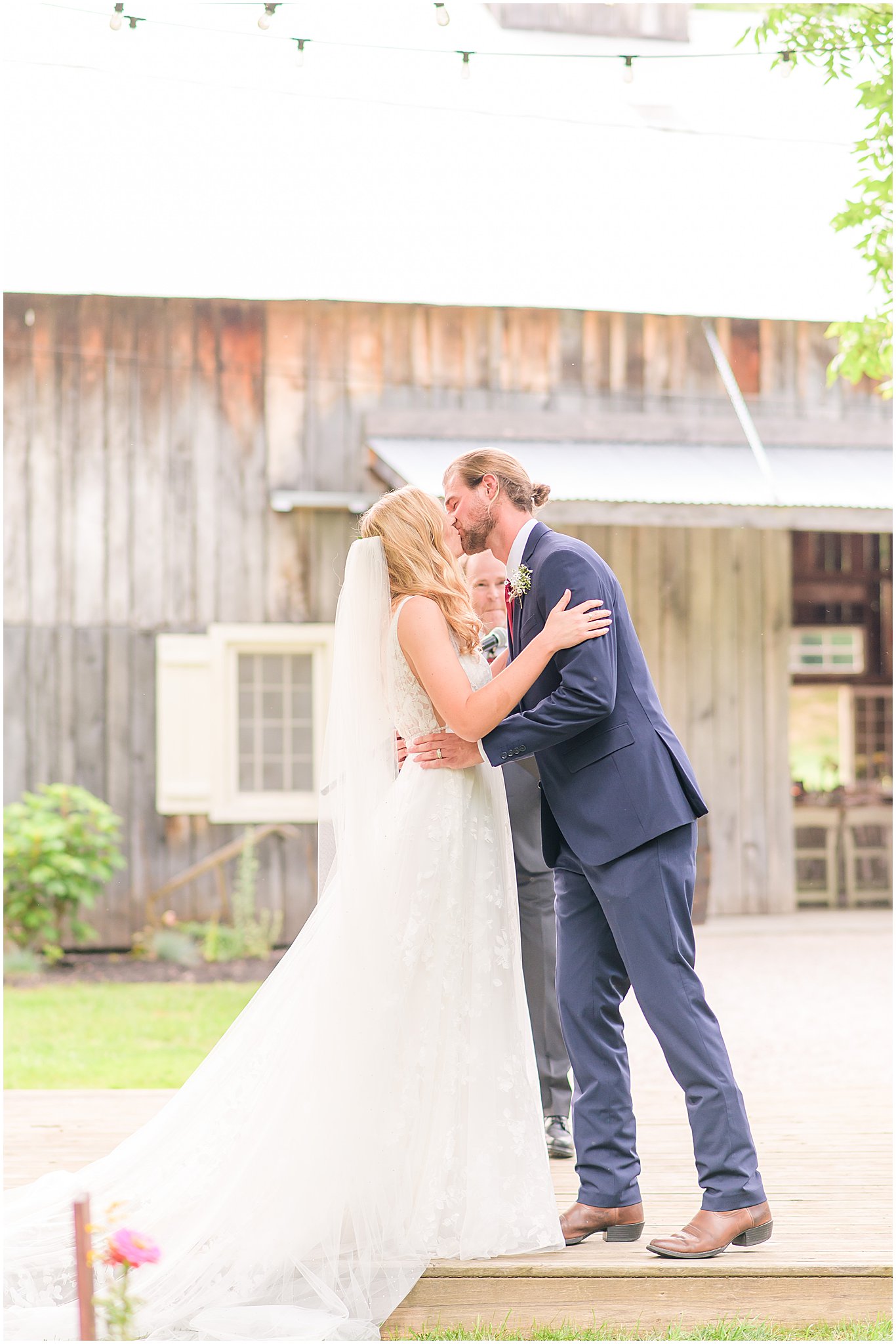 Bride and groom first kiss The Old Barn At Brown County wedding