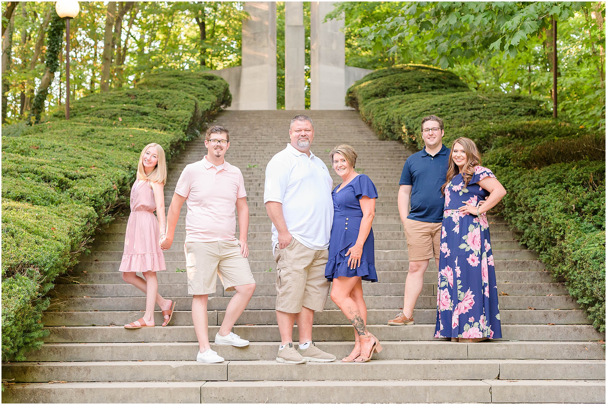 Family staggered in groups smiling at camera Holcomb Gardens family session
