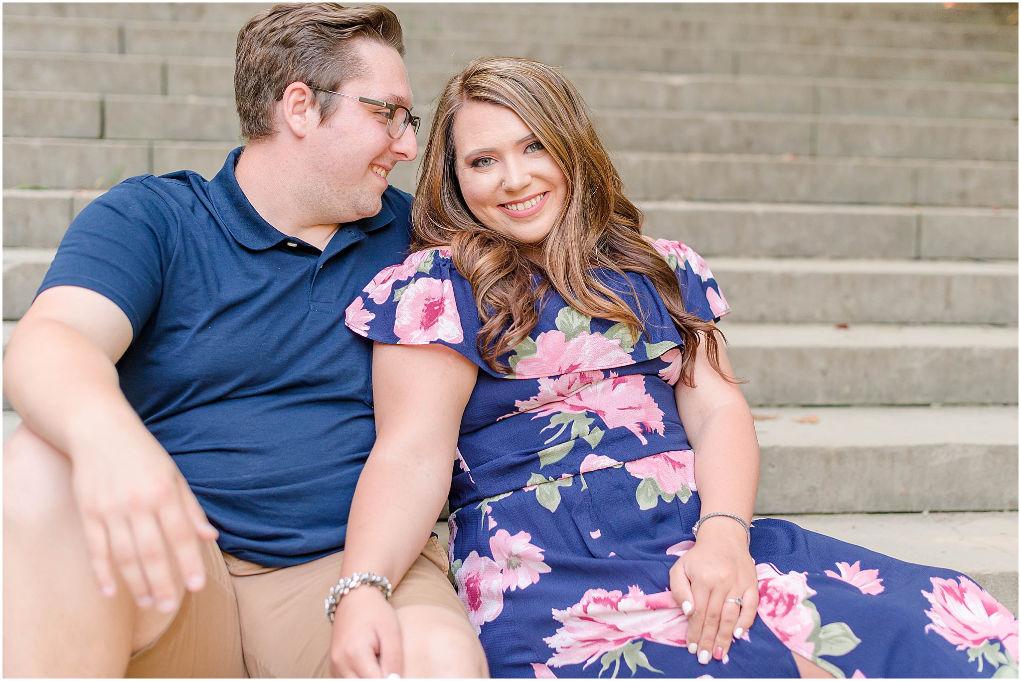 Couple sitting on stairs nuzzling Holcomb Gardens family session